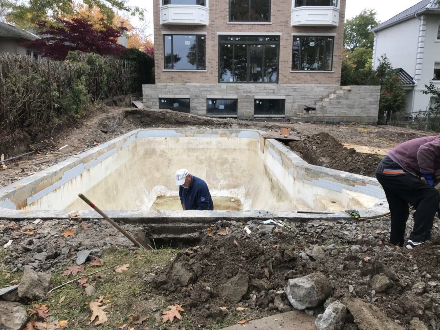 Backyard swimming pool renovation project in Toronto featuring demolition, excavation, and structural preparation. This stage includes removing old materials, reshaping the pool structure, and preparing the foundation for a complete pool rebuild and modern outdoor upgrade by an experienced Toronto contractor.