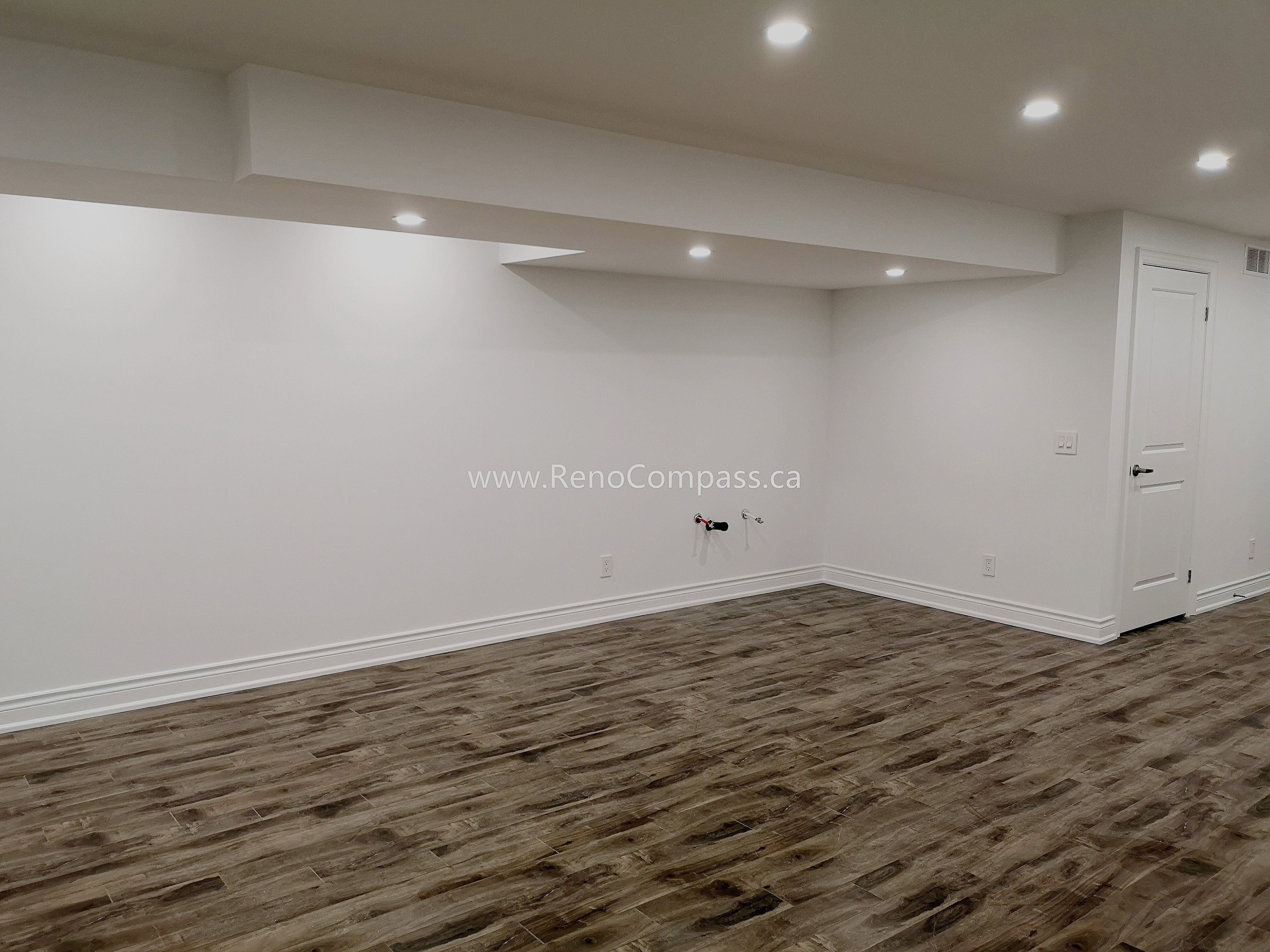 This Vaughan basement renovation project features a spacious open-concept layout with modern recessed lighting, upgraded flooring, and clean white wall finishes. The newly renovated basement offers a bright and functional living space ideal for entertainment, family use, or rental potential. Completed by Reno Compass Inc., this project highlights high-quality craftsmanship and efficient space planning, transforming an unfinished basement into a comfortable and modern extension of the home.