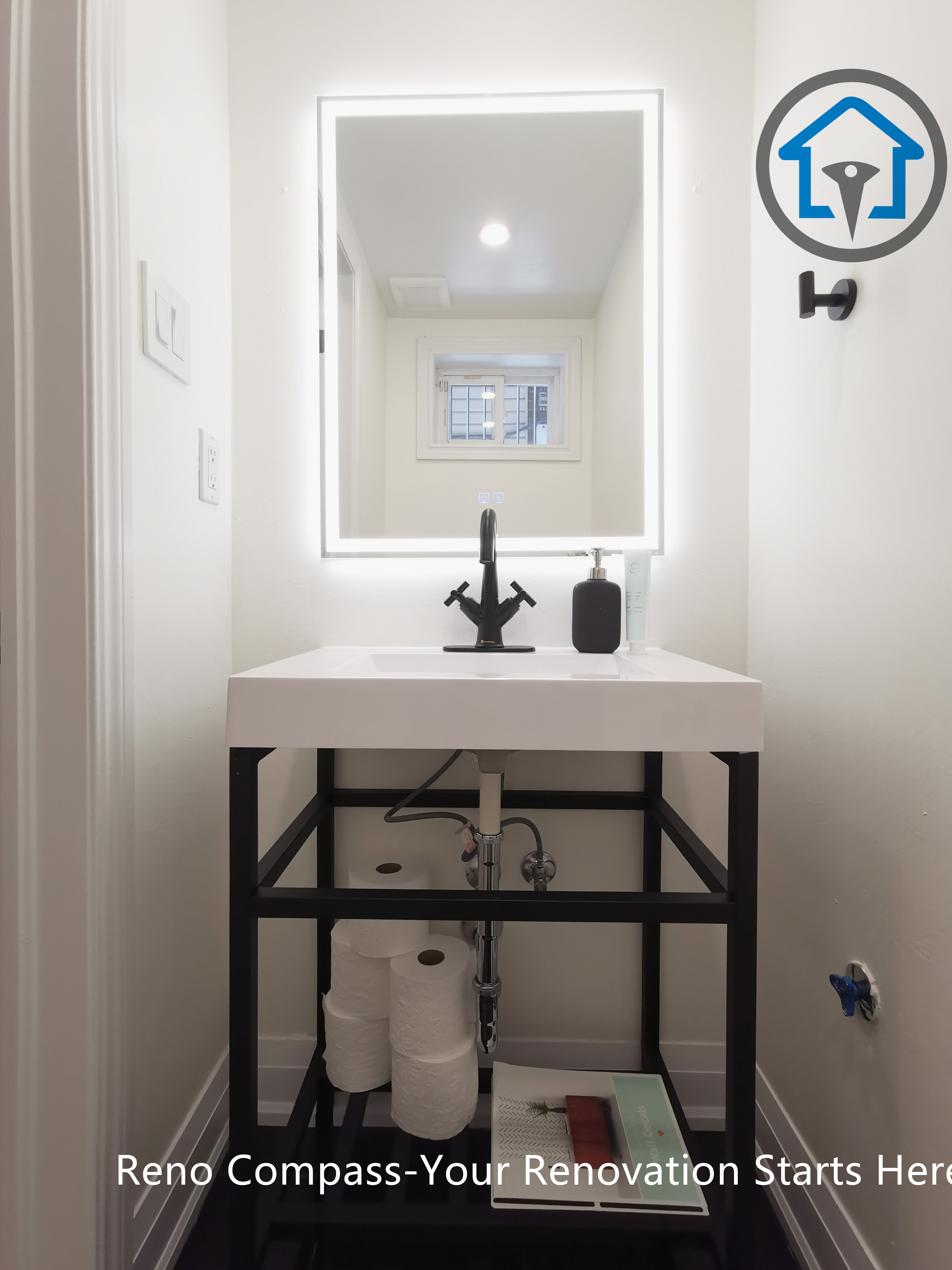 This North York basement renovation features a compact vanity with a quartz countertop, matte black faucet, and an LED backlit mirror. The clean-lined metal vanity frame and minimalist layout maximize functionality in a small basement bathroom space, completed by a Toronto renovation company focused on efficient design and precise installation.