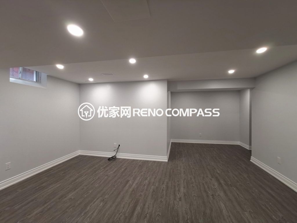 Richmond Hill basement interior renovation featuring new waterproof flooring, recessed pot lights, and a clean open-concept layout. The upgraded space offers bright lighting, modern finishes, and flexible functionality for family living or entertainment, completed by a professional Toronto renovation company.