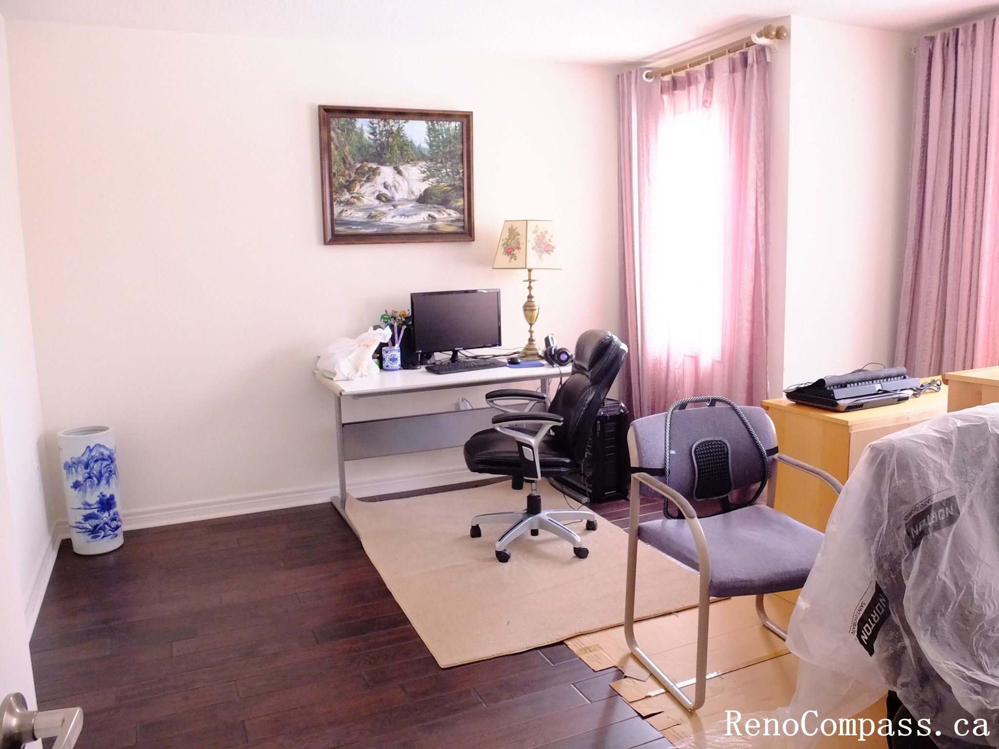 Toronto home hardwood flooring installation featuring deep-toned wood floors throughout the hallway and upper level. This professional flooring renovation enhances brightness, durability, and visual continuity, completed by Reno Compass for a clean and modern interior upgrade.