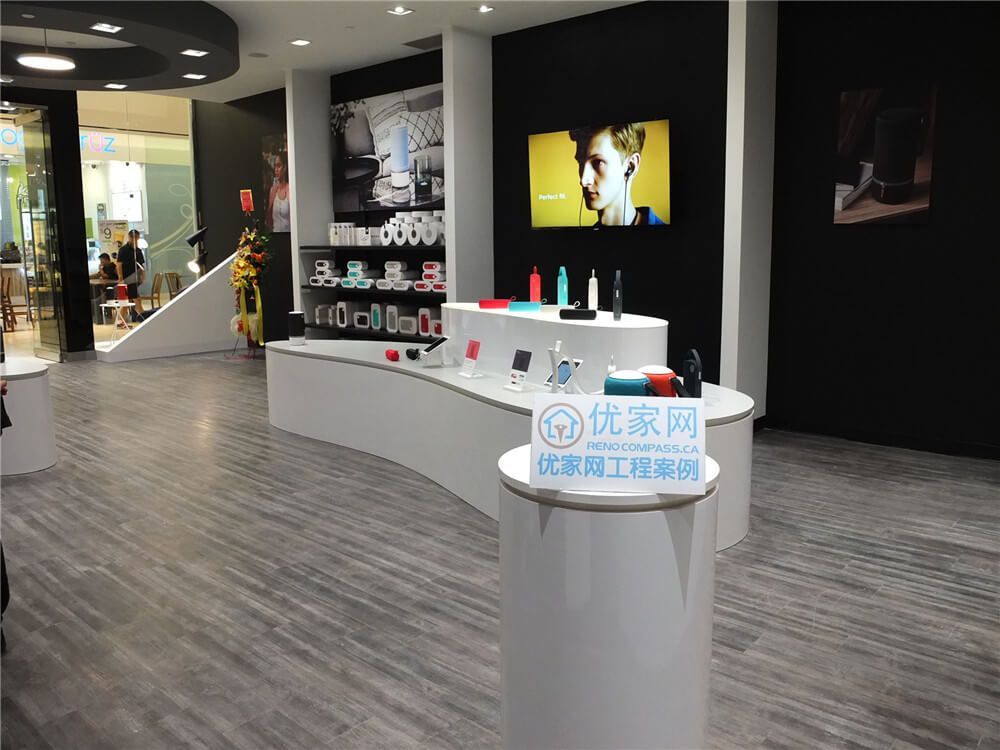 Modern retail store interior renovation inside Markville Mall featuring clean commercial flooring, custom product display counters, feature walls, integrated lighting, and digital display screens. This commercial renovation project focuses on creating a contemporary shopping environment with optimized customer flow, elegant product presentation, and durable finishes suitable for high-traffic retail spaces in a busy Toronto shopping mall.