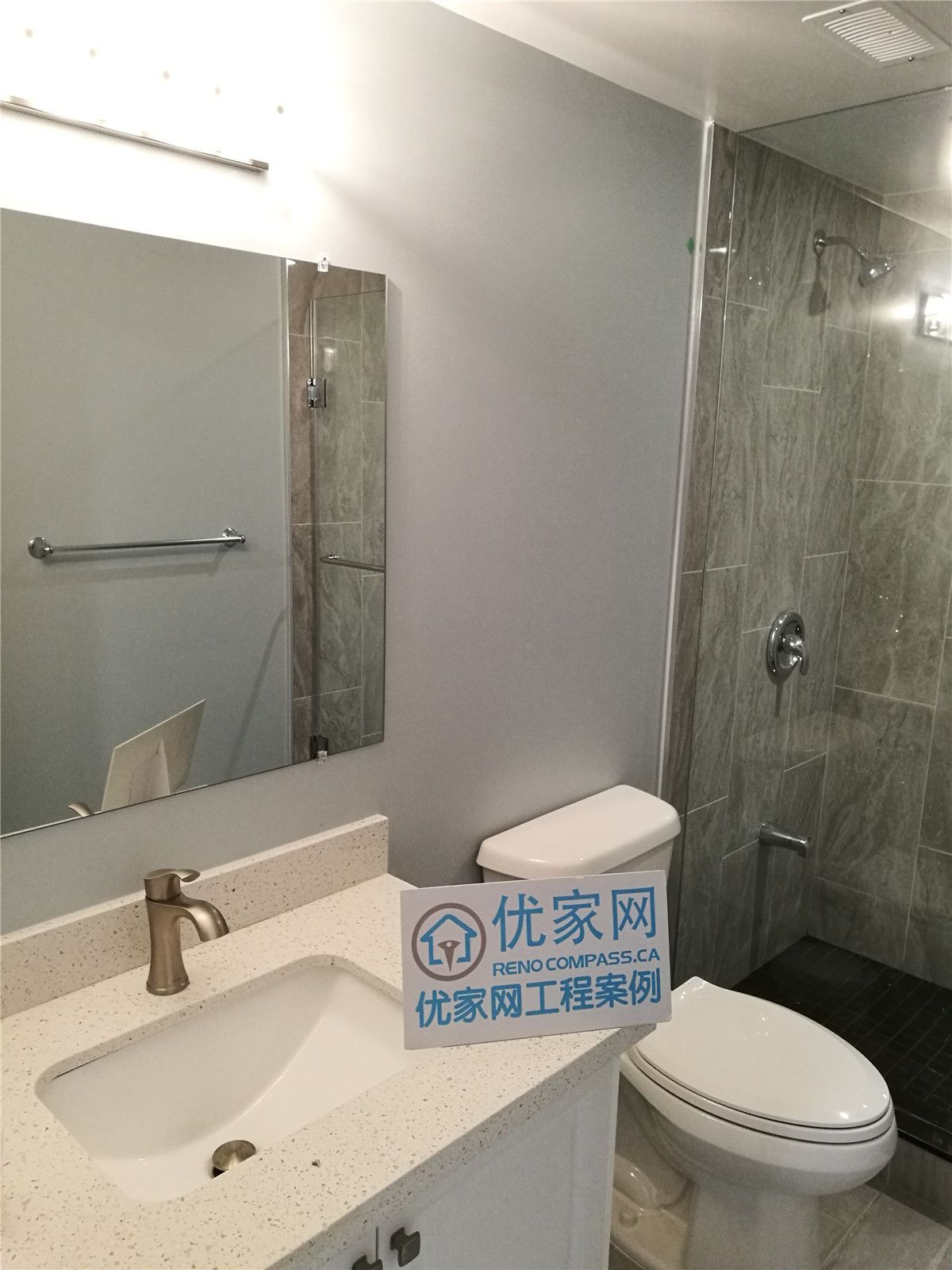 This image showcases a modern basement bathroom completed as part of a North York interior renovation. The space features a glass-enclosed shower, large-format tile finishes, a contemporary vanity, and clean plumbing fixtures. Neutral tones and durable materials enhance both functionality and visual appeal, creating a practical and comfortable bathroom design. This renovation reflects the quality workmanship of a professional Toronto renovation company serving the North York area.