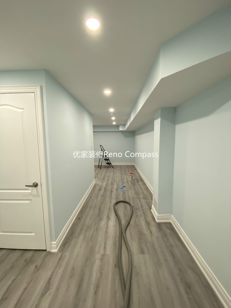 This Aurora basement renovation project showcases a fully upgraded lower-level living space completed by a professional Toronto renovation company. The basement features newly installed durable vinyl flooring, smooth finished walls, modern white trim, and evenly distributed LED pot lights to create a bright and comfortable environment. Clean lines, neutral tones, and an open layout transform the basement into a functional multi-purpose living area ideal for family use, rental potential, or entertainment space. Contractor: Reno Compass Inc.
