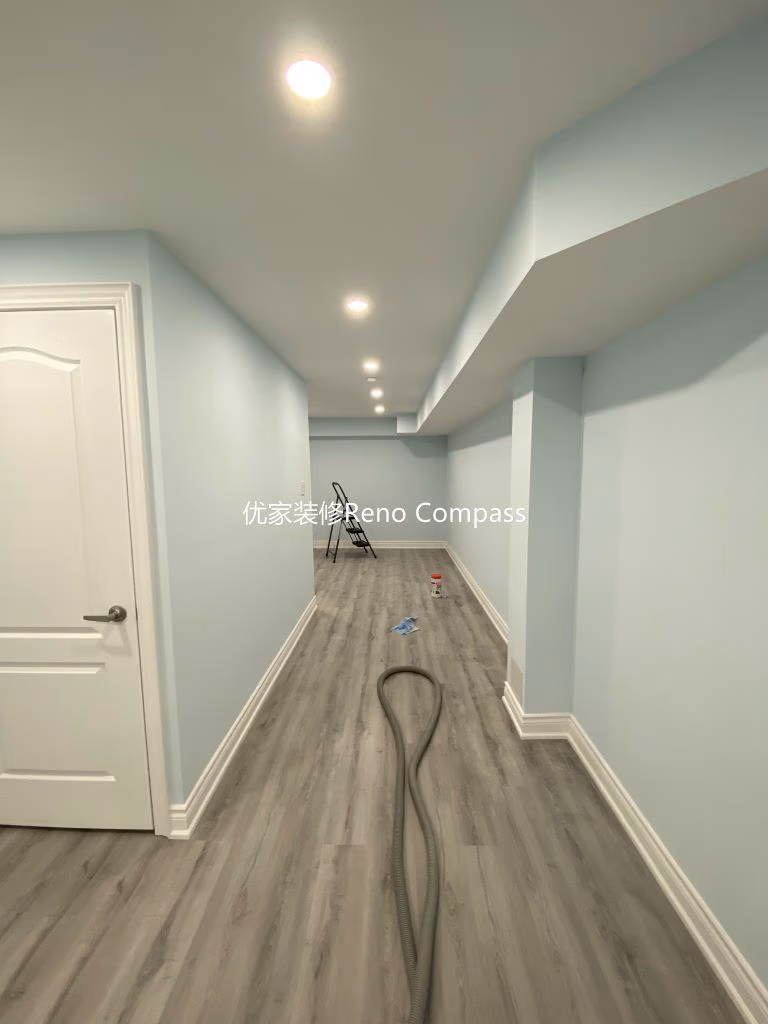 This Aurora basement renovation project showcases a fully upgraded lower-level living space completed by a professional Toronto renovation company. The basement features newly installed durable vinyl flooring, smooth finished walls, modern white trim, and evenly distributed LED pot lights to create a bright and comfortable environment. Clean lines, neutral tones, and an open layout transform the basement into a functional multi-purpose living area ideal for family use, rental potential, or entertainment space. Contractor: Reno Compass Inc.