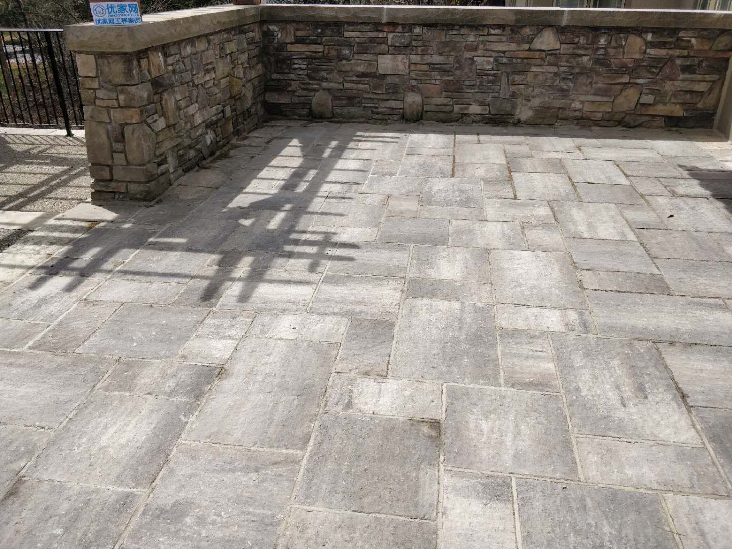 Oakville backyard renovation featuring a spacious interlock stone patio, custom pergola, and stone column detailing. Designed to create a durable, low-maintenance outdoor living and entertaining area.