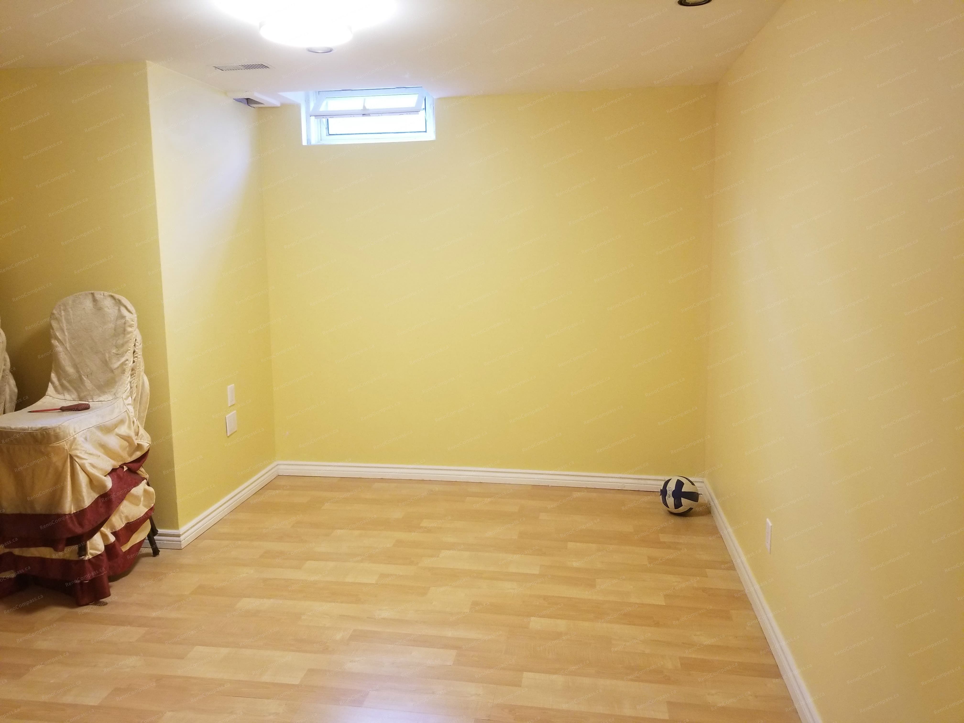 A completed basement room in this Vaughan basement renovation project, featuring fresh wall finishes, durable laminate flooring, and a bright, functional layout. The clean and flexible space is ideal for use as a guest room, home office, or recreation area. Renovation completed by a professional Toronto renovation company with attention to comfort and practicality.