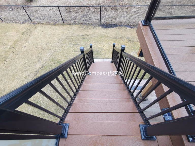 Professional deck construction project in Aurora featuring durable composite wood decking, modern black aluminum and glass railings, and a spacious outdoor layout. Designed for long-term durability and low maintenance, this backyard deck enhances outdoor comfort, safety, and property value.