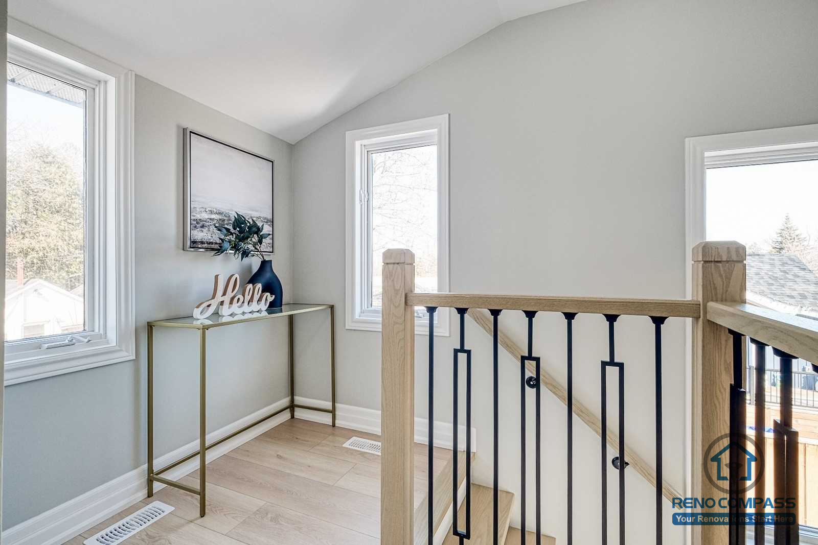This Georgian interior renovation highlights a bright stair landing with clean railing details, light wood flooring, and natural light from multiple windows. Subtle finishes and balanced proportions reflect the craftsmanship of a Toronto renovation company.
