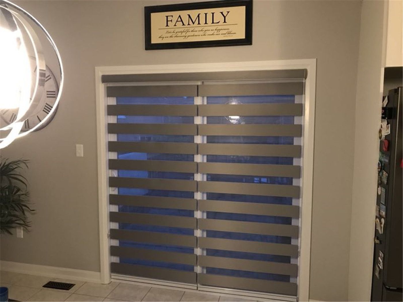 Modern zebra blinds installed on a sliding door in a Toronto home, offering adjustable light filtering and privacy. This dual-layer design creates a clean, contemporary look while maximizing functionality.