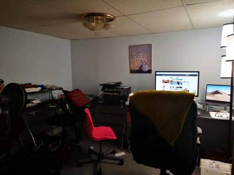 This pre-renovation basement space in Mississauga features a compact home office setup with drop ceiling, basic lighting, and limited layout efficiency. The area highlights the need for improved lighting, space optimization, and modern finishes, setting the foundation for a professional Toronto renovation company to transform it into a functional and stylish workspace.
