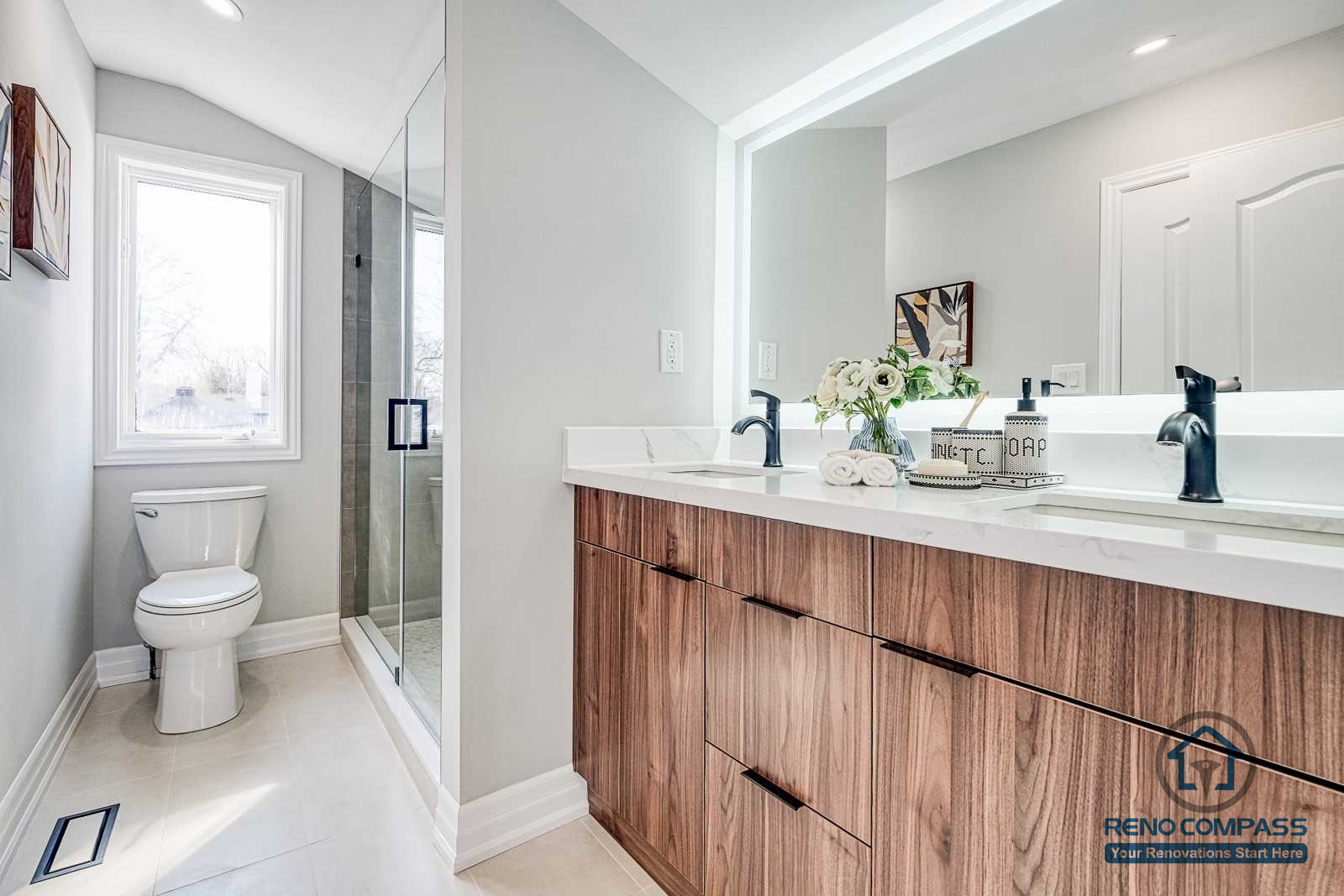 This Georgian interior renovation features a modern bathroom with a custom wood vanity, clean countertop, glass shower enclosure, and soft natural light. The design blends classic proportions with contemporary finishes, completed by a Toronto renovation company.
