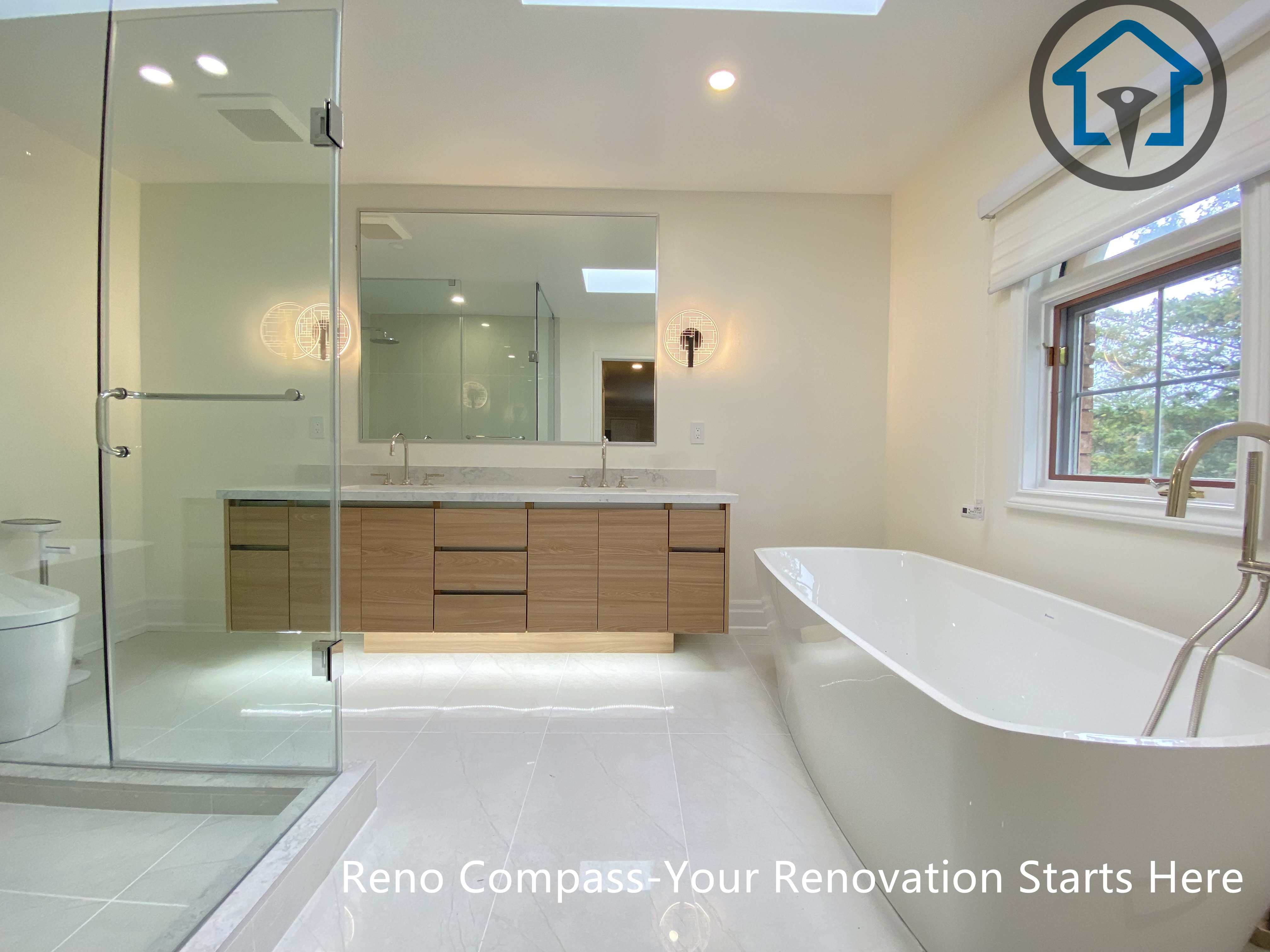 A modern bathroom renovation featuring a freestanding bathtub, glass-enclosed shower, and custom wood vanity with integrated lighting. Designed for a clean, spacious, and functional layout in a Thornhill home by Reno Compass.