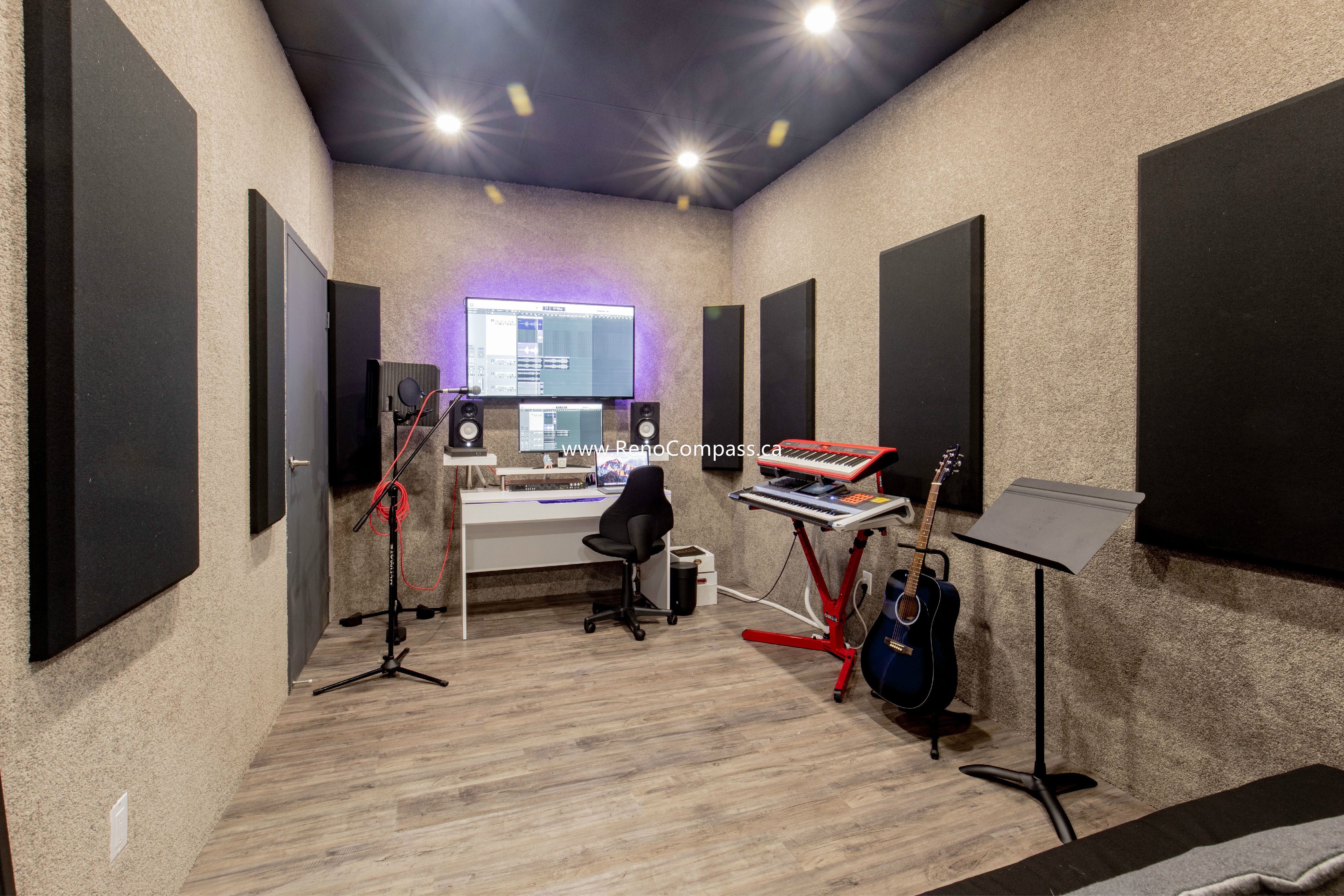 A specialized commercial renovation of a soundproof recording studio at The Singing School. Featuring professional acoustic wall panels, recessed LED lighting, textured sound-dampening walls, and durable wood-finish flooring. Expert studio construction services in Richmond Hill.