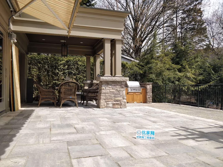 Oakville backyard covered patio featuring stone columns, architectural pillars, and a spacious seating area. Designed for comfort, shade, and elegant outdoor living.