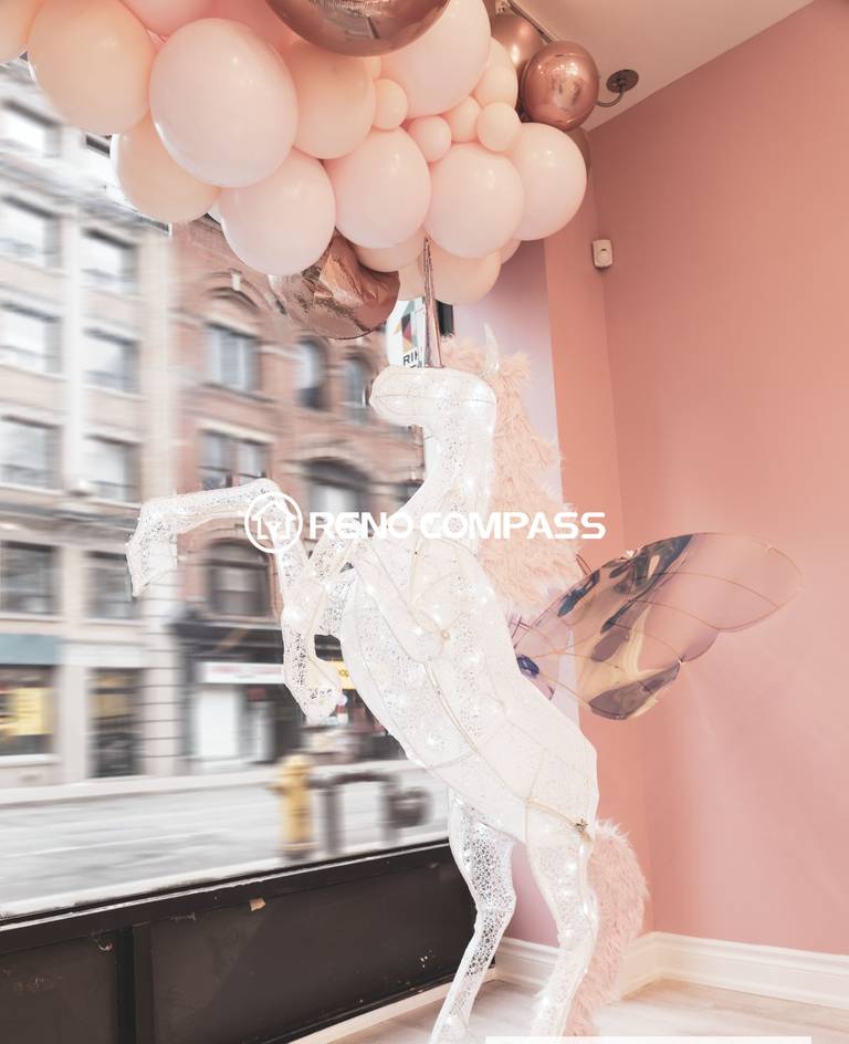 This Toronto beauty store commercial renovation features a charming window display area designed with soft pink tones, decorative balloons, and a unique winged horse sculpture. The stylish retail interior creates a visually striking storefront that attracts customers and enhances the brand’s aesthetic identity. Completed by a professional Toronto renovation company, the design combines creative decoration with modern retail presentation to elevate the shopping atmosphere.