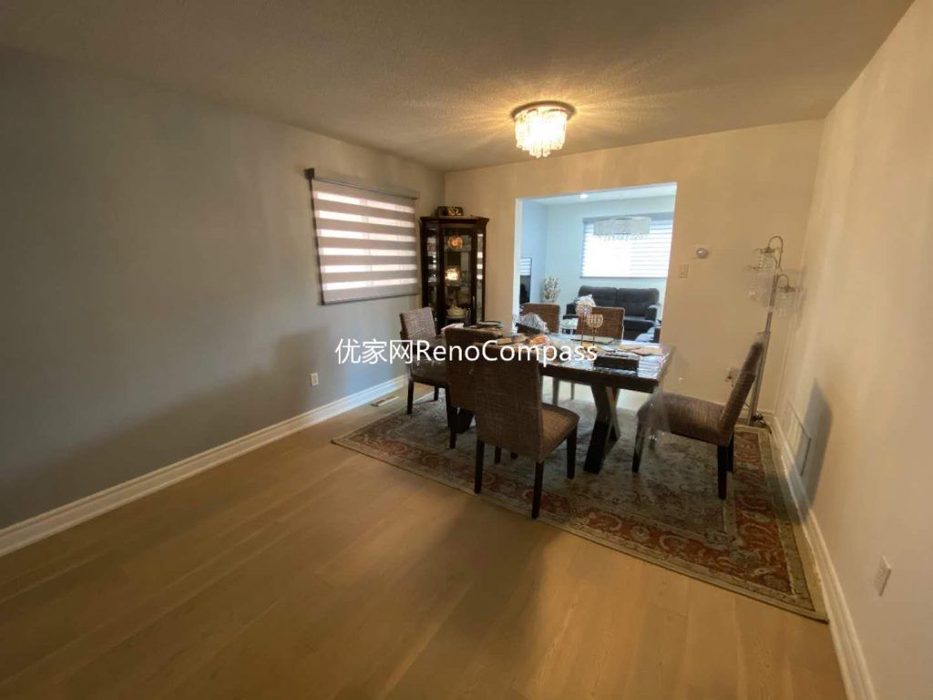 This image showcases a completed dining area renovation in Mississauga, highlighting upgraded wood flooring, clean wall finishes, and a refreshed lighting fixture that enhances the overall warmth of the space. The open connection to the adjacent living area improves flow and usability, making the dining room suitable for both daily family use and entertaining. Neutral wall tones and consistent flooring create visual continuity throughout the main level, reflecting a thoughtful interior renovation approach. This project demonstrates the functional planning and craftsmanship expected from a professional Toronto renovation company focused on long-term comfort and livability.