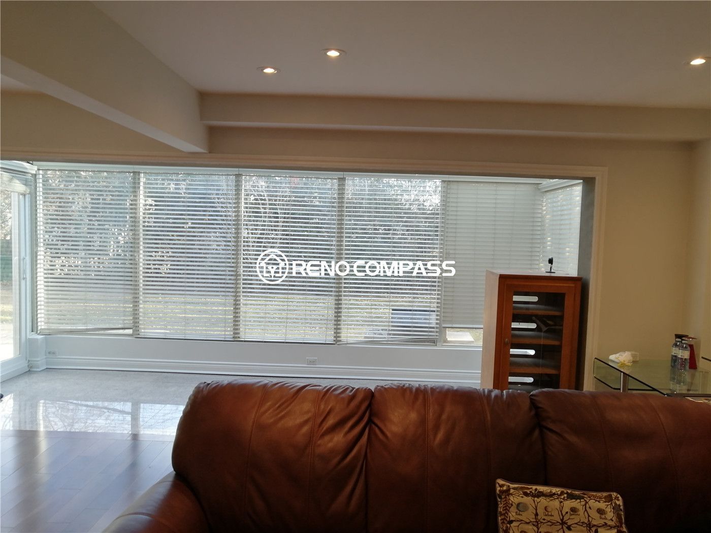 This bright sunroom is part of a North York interior renovation, designed to maximize natural light and create a relaxing transition space within the home. Large wraparound windows with blinds allow daylight to fill the room while maintaining privacy. Recessed ceiling lighting enhances evening use, and the open layout supports flexible furniture placement. The clean finishes, smooth flooring transition, and thoughtful lighting design reflect the craftsmanship and attention to detail expected from a professional Toronto interior renovation project.