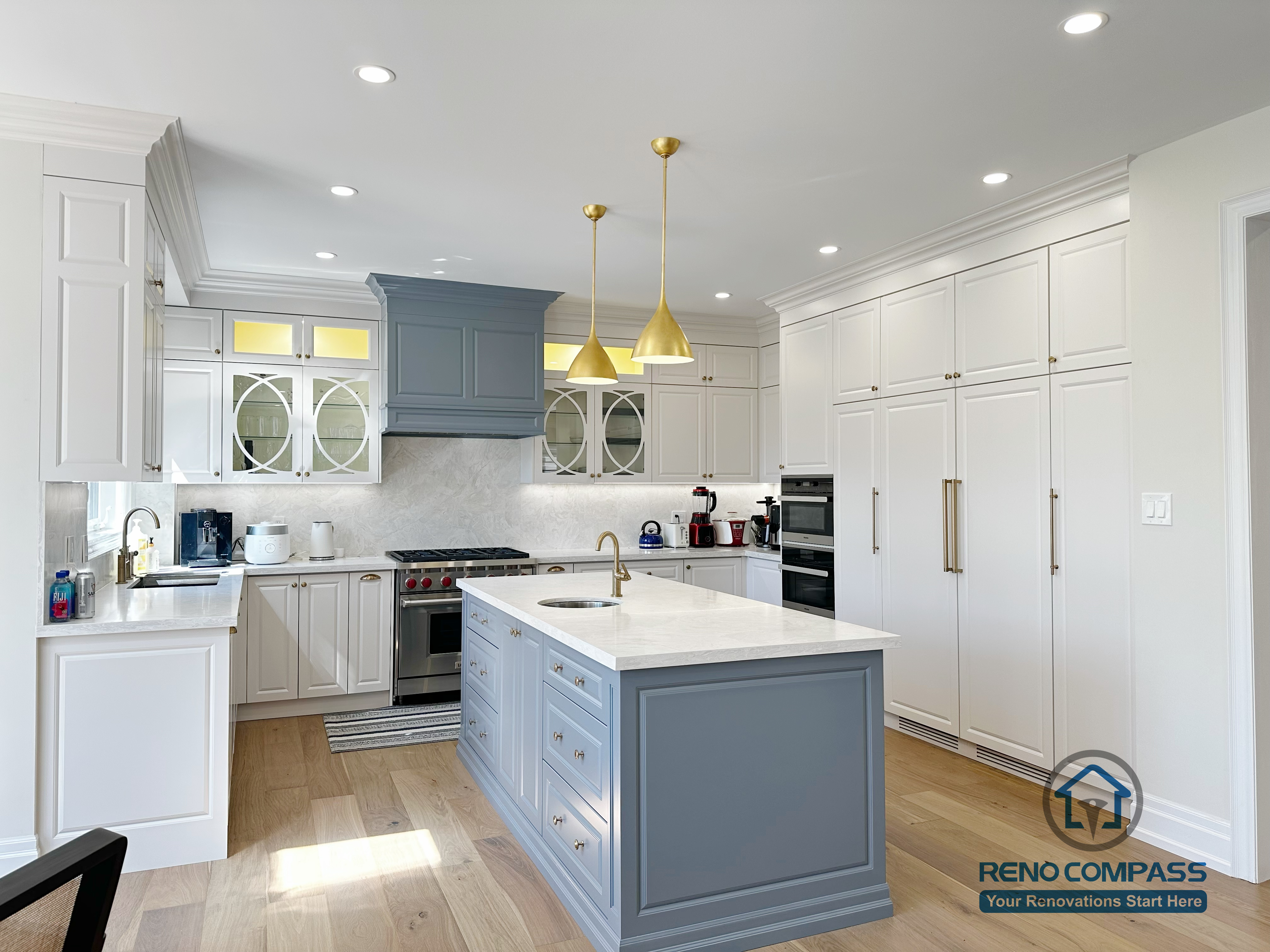 This North York kitchen renovation showcases a symmetrical layout centered around a custom island, with full-height cabinetry, balanced lighting, and clear circulation paths. The design emphasizes proportion, alignment, and everyday usability, creating a calm and organized kitchen environment completed by Reno Compass.