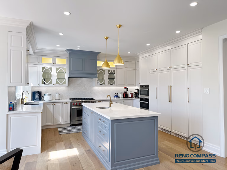 This North York kitchen renovation showcases a symmetrical layout centered around a custom island, with full-height cabinetry, balanced lighting, and clear circulation paths. The design emphasizes proportion, alignment, and everyday usability, creating a calm and organized kitchen environment completed by Reno Compass.