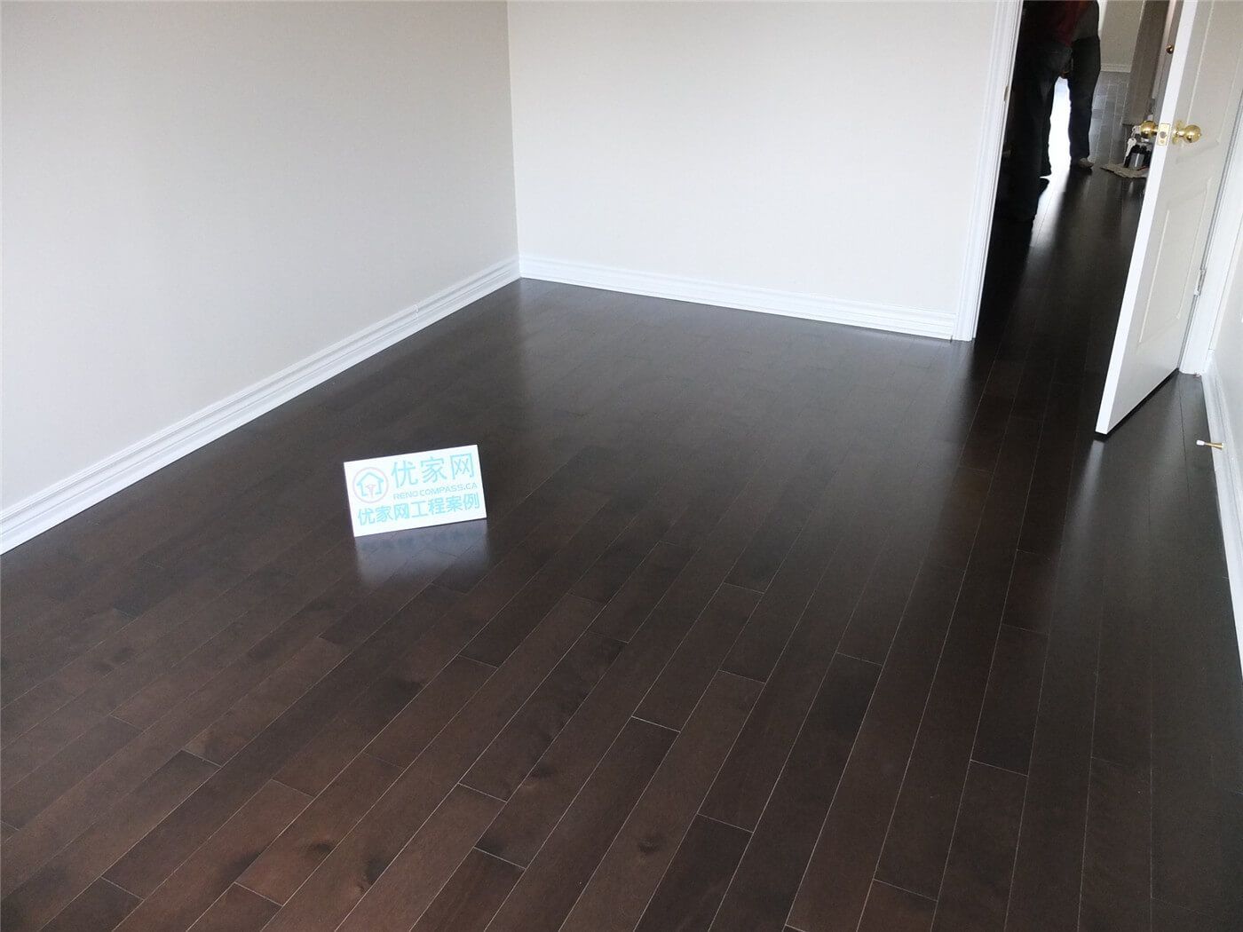 Finished dark hardwood flooring installation in a Toronto home renovation project, showing clean floor alignment, modern baseboards, and professional interior flooring upgrade by a Toronto renovation company.