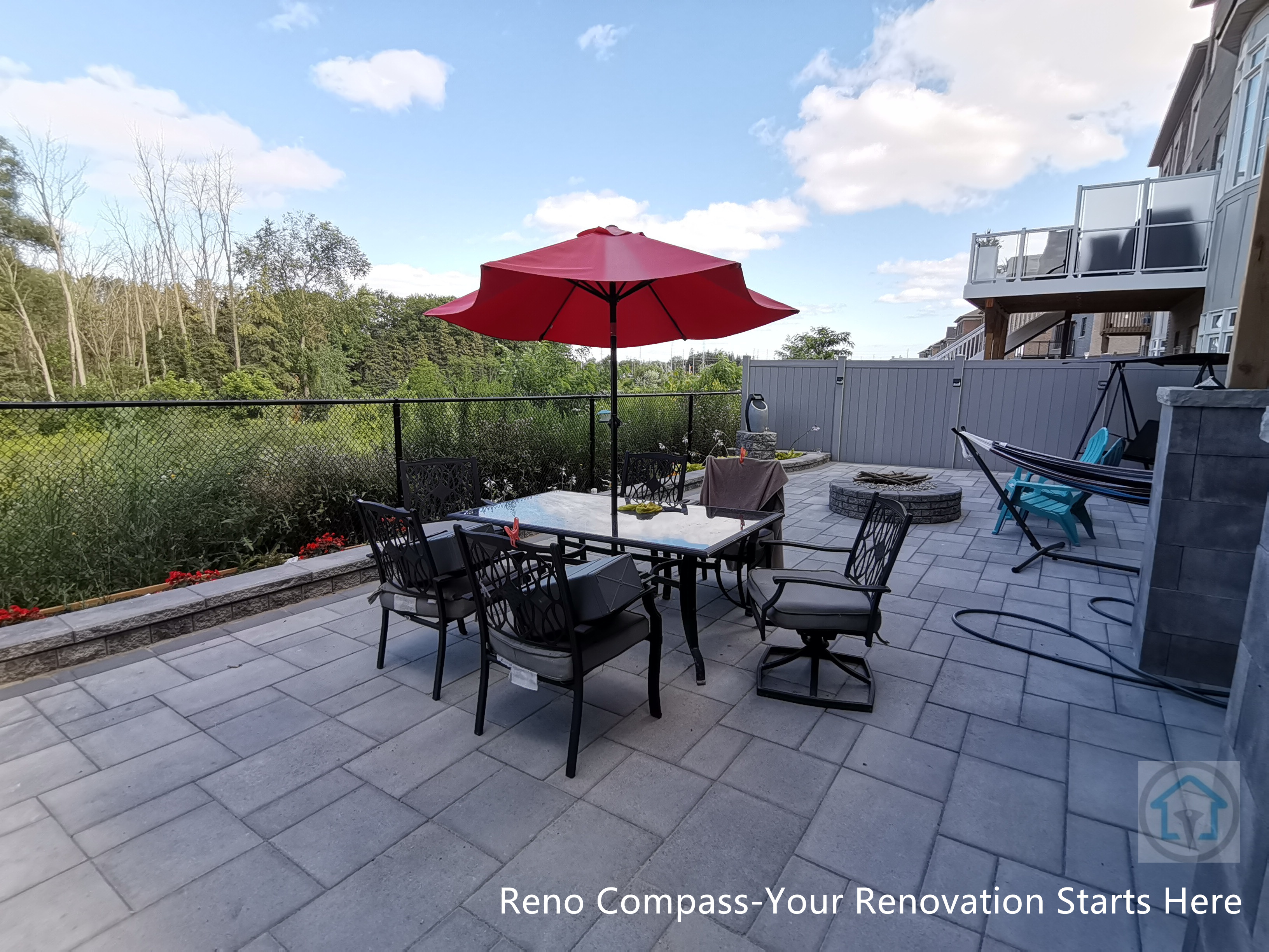This Vaughan backyard interlocking patio features a spacious stone paver layout designed for outdoor dining and relaxation. The clean paving pattern supports patio furniture and daily use, while the open layout connects seamlessly with the deck structure and fencing, creating a comfortable and functional outdoor living space.