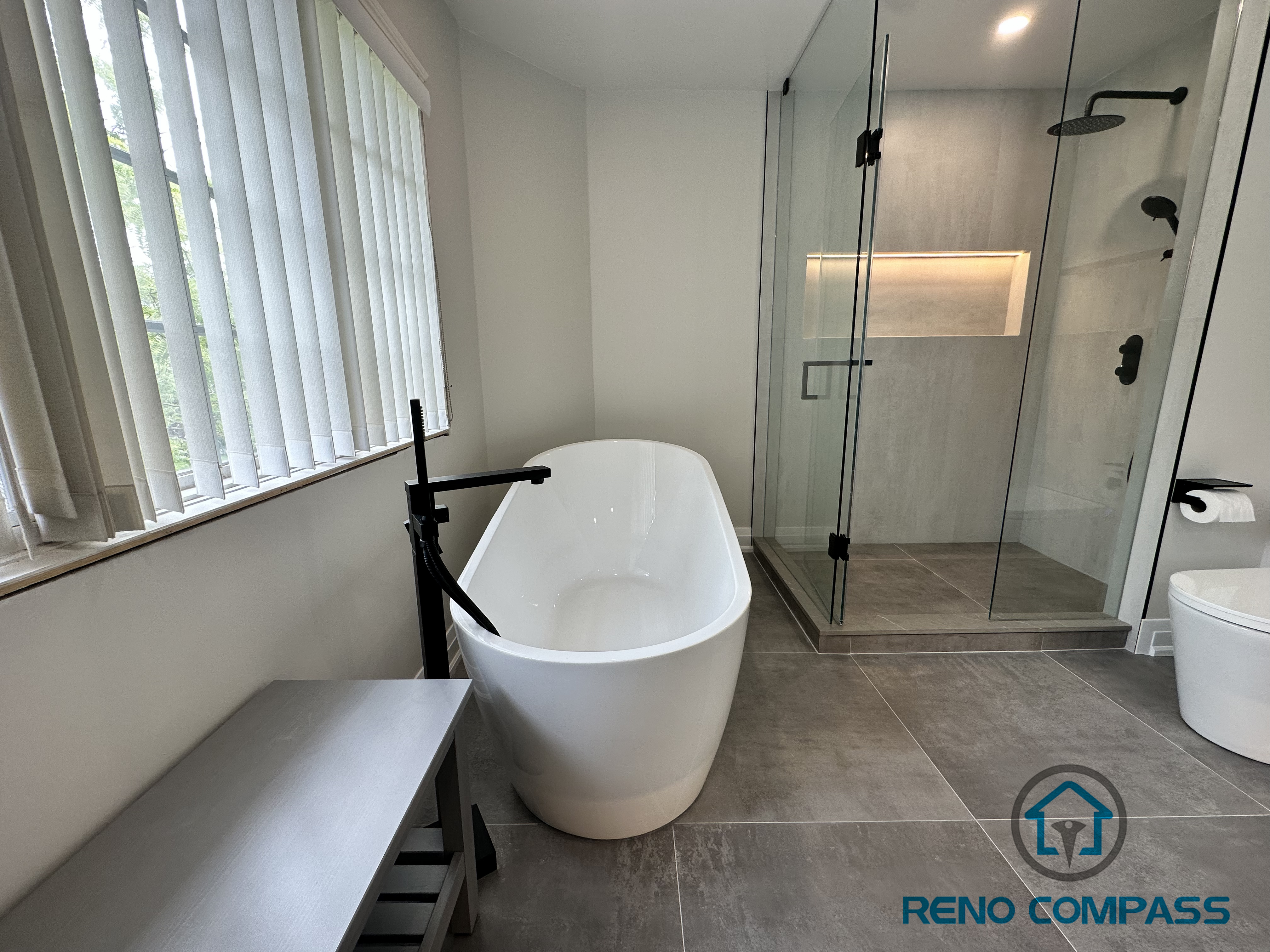 This custom walk-in shower in an Oakville home includes a frameless glass enclosure, built-in niche storage, and integrated LED strip lighting for both functionality and ambiance. Perfect for modern, low-maintenance bathroom upgrades.