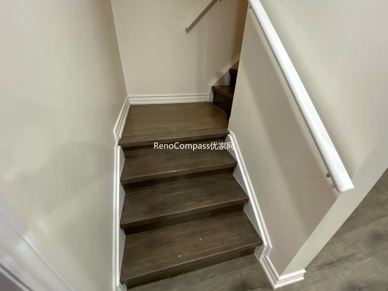Basement staircase renovation in Richmond Hill featuring modern dark wood steps, upgraded handrails, and clean wall finishes. Completed by a professional Toronto renovation company, this basement upgrade enhances safety, durability, and visual appeal while creating a seamless transition between main floor and finished basement living space.