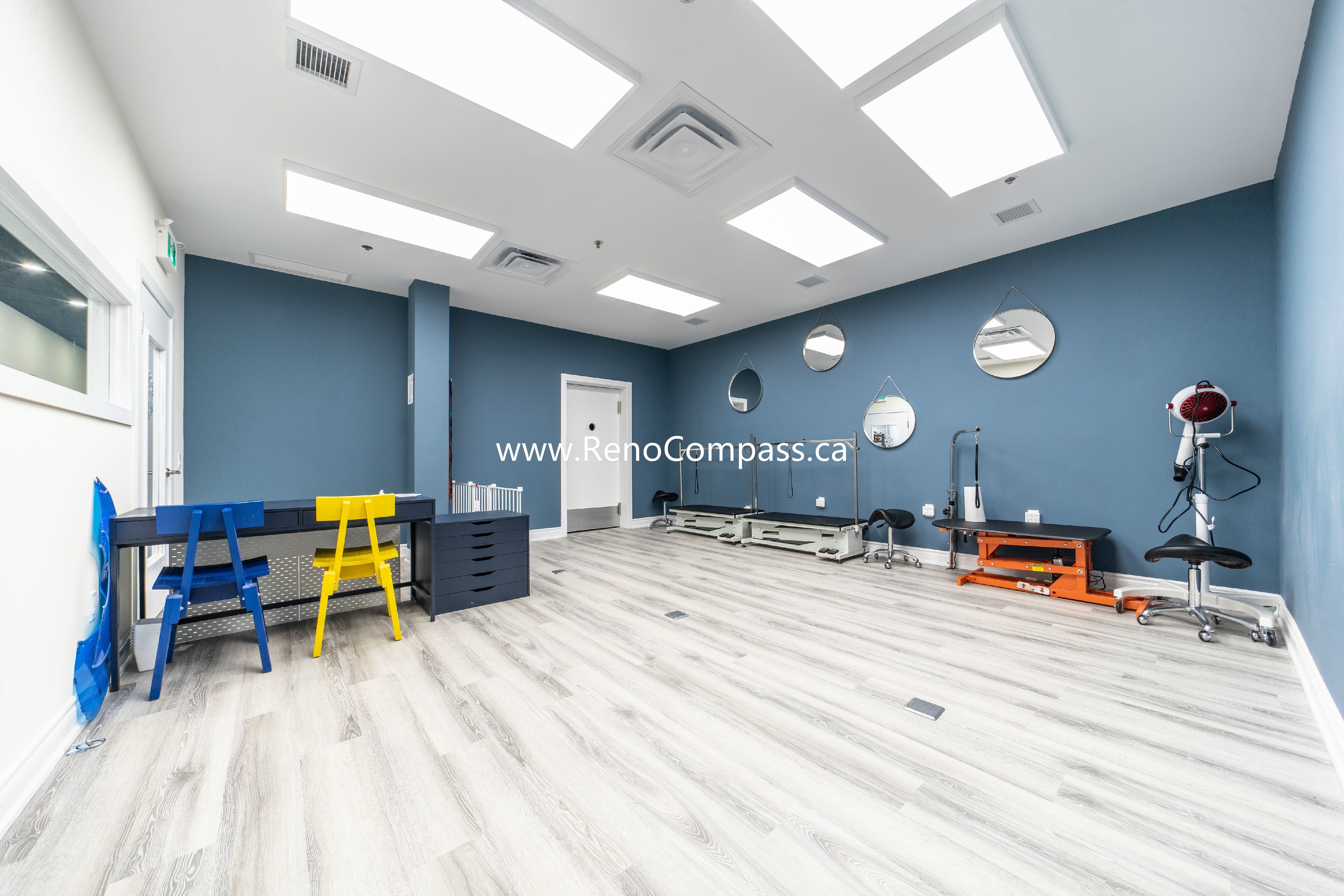 Installation of flooring and ceiling lights in progress at Q’s Pets, Richmond Hill pet store renovation.