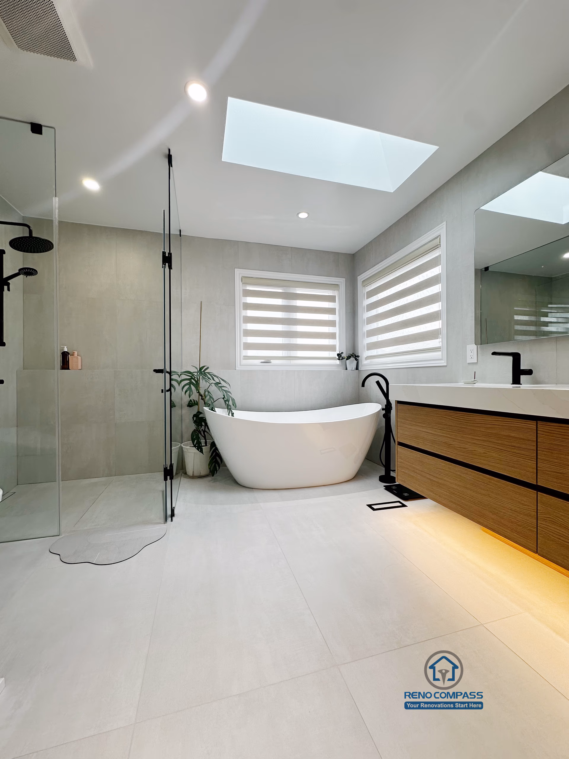 A floor-level view of a curbless bathroom renovation by Reno Compass in Markham, Toronto.
This image highlights the seamless tile flooring, integrated linear drainage, and warm under-vanity lighting that enhance accessibility, safety, and visual continuity.
