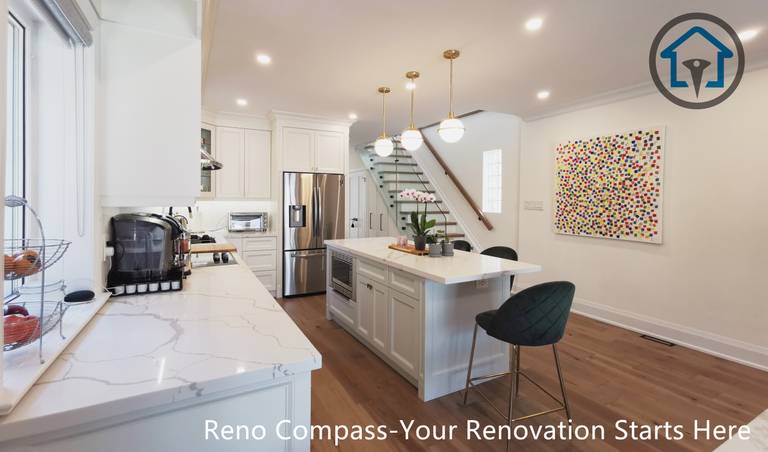This image captures a layered perspective of the kitchen in a North York interior renovation, showcasing the relationship between the main countertop, central island, and staircase. The custom island features quartz surfaces, built-in storage, and seating, highlighted by warm pendant lighting above. White shaker cabinetry and stainless steel appliances create a clean, timeless backdrop, while continuous hardwood flooring enhances spatial flow. The open staircase and adjacent art wall add depth and visual interest without interrupting circulation. Completed by a Toronto renovation company, this renovation reflects careful planning, functional zoning, and a refined open-concept interior design.