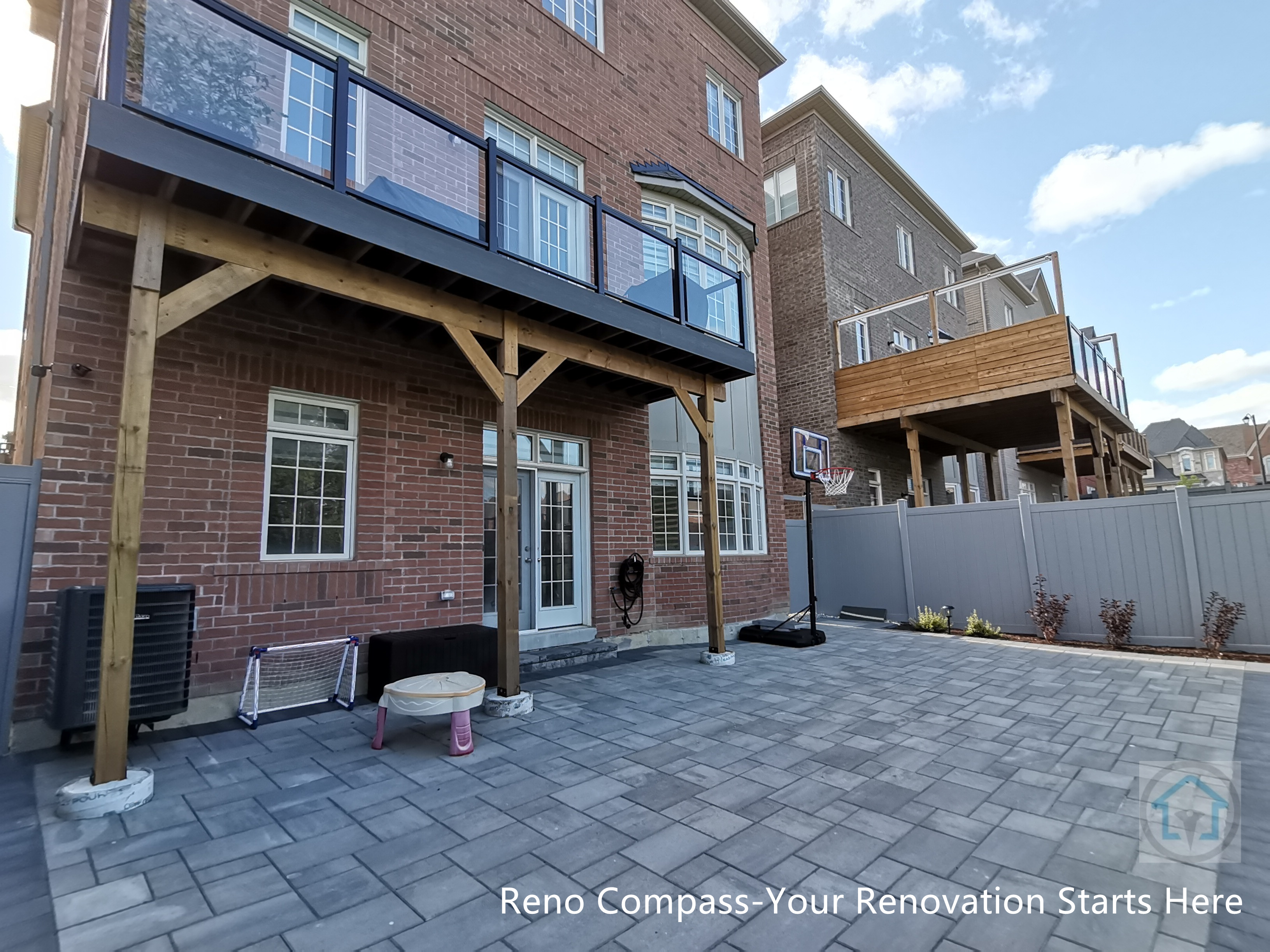 This Vaughan backyard renovation combines a covered wood deck structure with a spacious interlocking stone patio. The elevated deck provides shaded outdoor living space, while the durable paver surface below supports everyday use, play, and entertaining. The design creates a functional, low-maintenance backyard that integrates seamlessly with the home’s architecture.