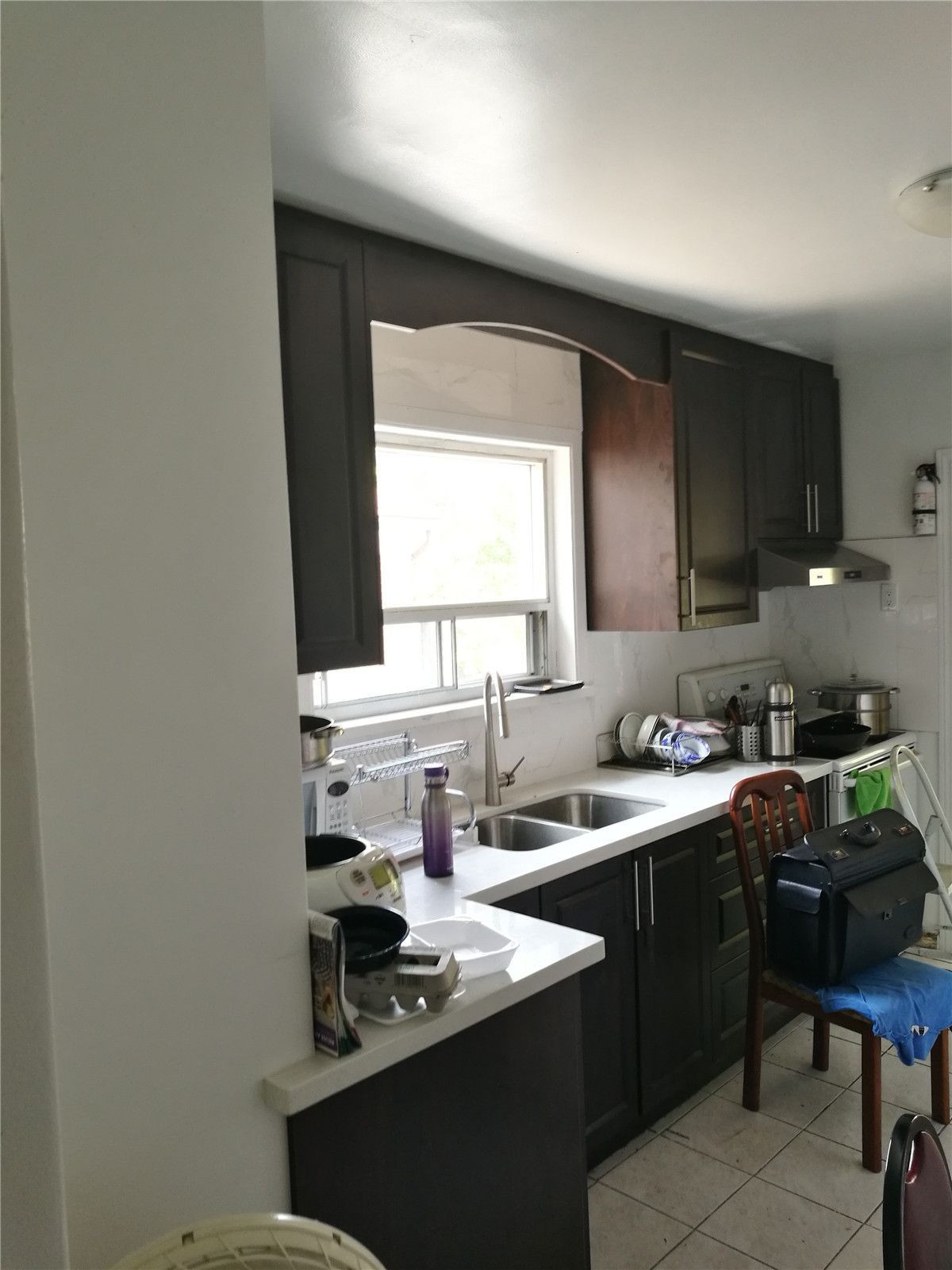Existing kitchen condition in a Richmond Hill home before renovation, featuring dark cabinetry, compact layout, limited counter space, and outdated finishes. This image documents the original kitchen layout prior to a full kitchen renovation by a professional Toronto renovation company, serving as a clear before-reference for the remodeling project.