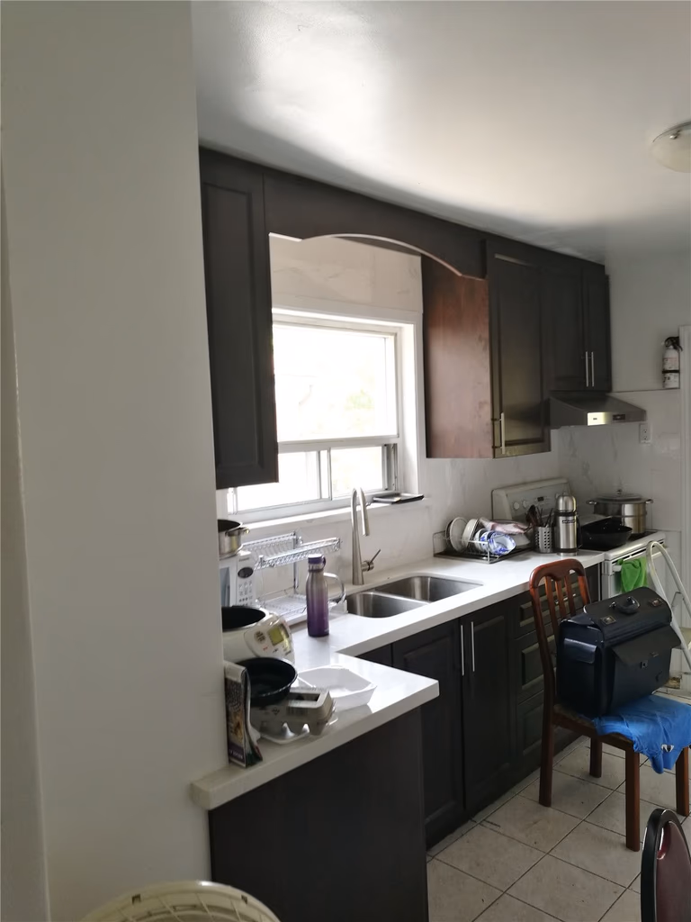 Existing kitchen condition in a Richmond Hill home before renovation, featuring dark cabinetry, compact layout, limited counter space, and outdated finishes. This image documents the original kitchen layout prior to a full kitchen renovation by a professional Toronto renovation company, serving as a clear before-reference for the remodeling project.