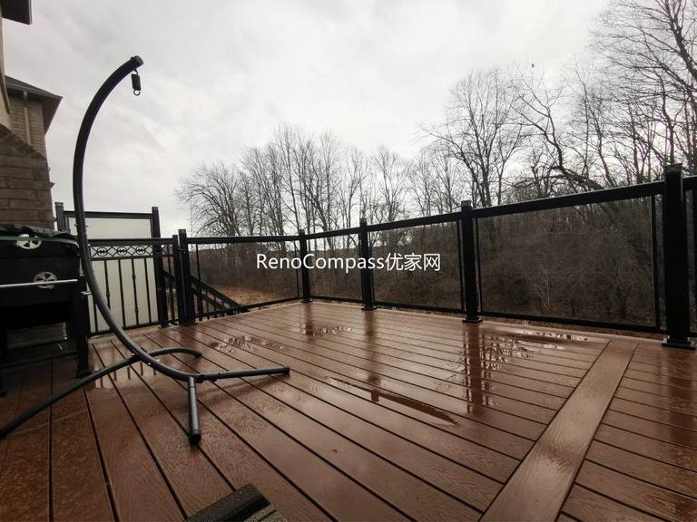 Aurora backyard deck renovation featuring premium composite decking, sleek black aluminum and glass railings, and professional outdoor construction. Designed for durability and low maintenance, this modern deck provides a safe, stylish, and functional outdoor living space while enhancing overall property value.