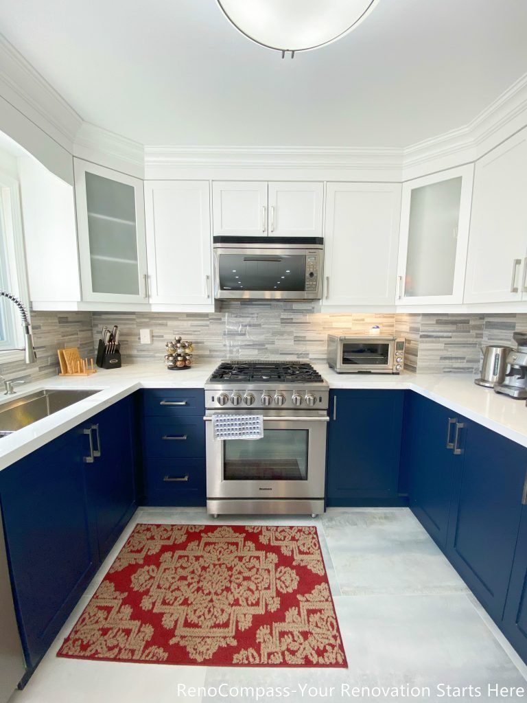 A detailed view of the kitchen cooking area from a Newmarket interior renovation, featuring a gas range, built-in microwave, quartz countertops, and custom cabinetry designed for everyday functionality by a Toronto renovation company.