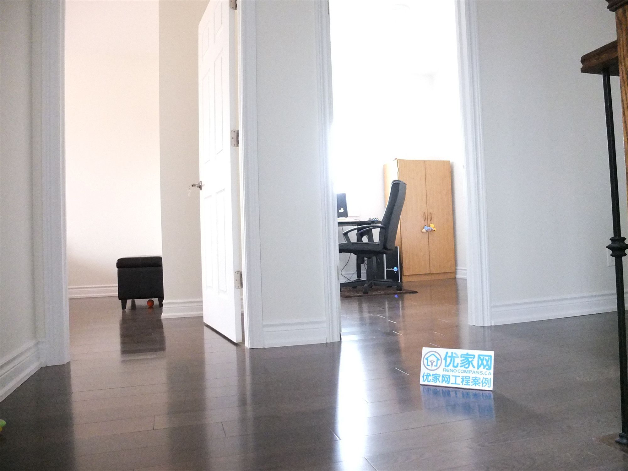 Interior view of a Scarborough home addition project featuring newly installed hardwood flooring, bright hallway space, and upgraded room layout. The renovation improves interior flow, lighting, and modern living comfort as part of a complete home expansion project.