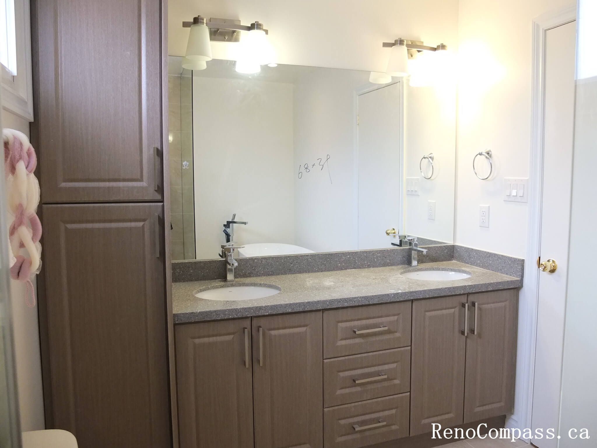 Bathroom renovation in North York featuring a double sink vanity, wall-mounted mirrors, quartz countertop, and integrated lighting. This Toronto interior renovation focuses on shared-use efficiency, balanced layout, and clean modern finishes suitable for family bathrooms.