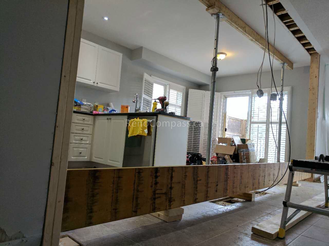 This Vaughan kitchen renovation showcases the remodeling process during construction, including structural opening expansion and layout reconfiguration to create a more open-concept kitchen. Reno Compass Inc. redesigned the space to improve flow, lighting, and functionality, preparing for new cabinetry, countertops, and modern finishes. Professional demolition and framing work ensure a strong foundation for a stylish and efficient kitchen transformation.