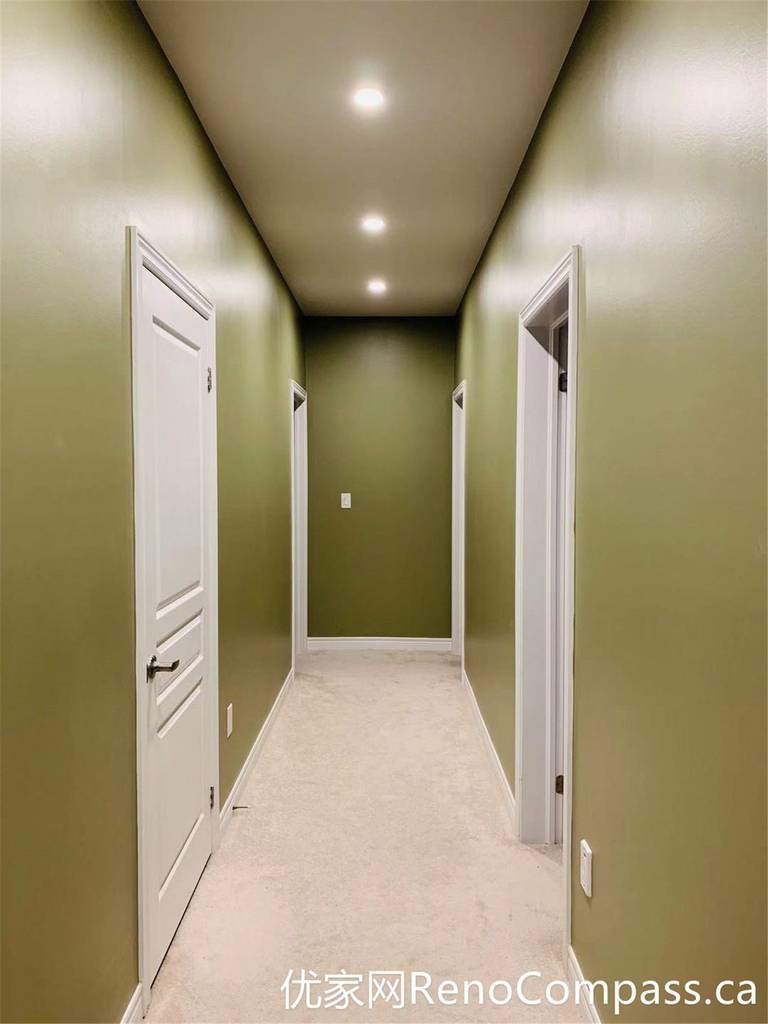 This hallway from a Markham full home renovation features soft green walls, clean white trim, and a simple, functional layout. Natural light enhances the depth of the space, while the updated finishes create a cohesive transition between rooms with a calm and modern feel.