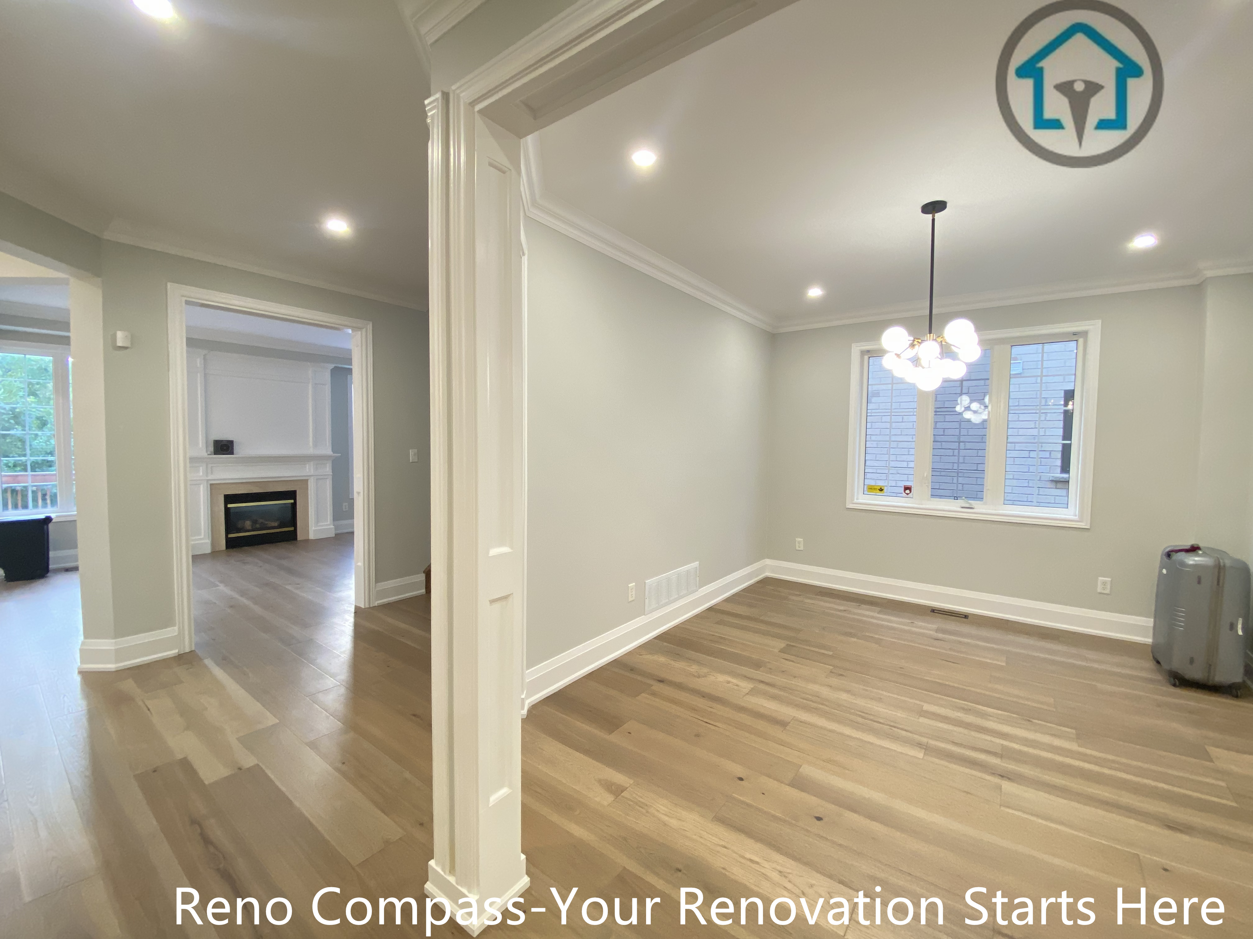 This image captures an open-concept interior space completed as part of a flooring renovation project in Richmond Hill. The renovation features continuous hardwood flooring across connected rooms, soft neutral wall tones, recessed ceiling lighting, and modern light fixtures that enhance spatial flow and brightness. Clean door trim and smooth transitions between living and dining areas create a cohesive and functional layout. Completed by a professional Toronto renovation company, this project emphasizes comfort, durability, and a timeless modern residential design.