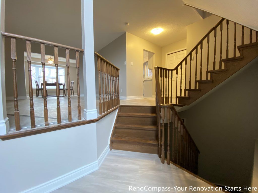 This Mississauga interior renovation highlights a well-connected staircase and hallway area featuring solid wood steps and matching railings. The multi-level layout improves circulation between floors, while the warm wood tones add visual continuity to the surrounding living spaces. Clean finishes, neutral wall colors, and balanced lighting create a cohesive transition area that enhances both functionality and overall interior flow.