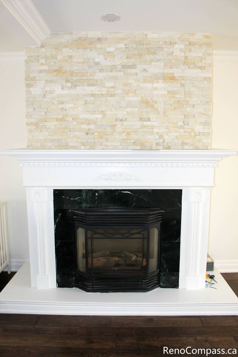 This Mississauga interior renovation showcases a beautifully upgraded fireplace area featuring a custom stone feature wall, classic white mantel design, and premium hardwood flooring. The renovation enhances the living space with a warm focal point and elegant finishes, combining modern comfort with timeless style. Completed by a professional Toronto renovation company, Reno Compass Inc., this project highlights quality craftsmanship and refined interior detailing.
