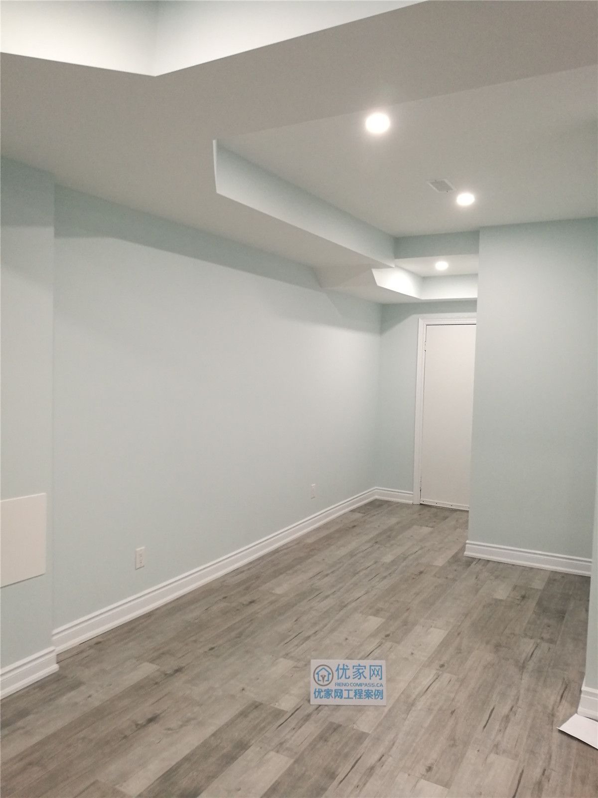 This newly finished basement room in Vaughan features durable wood-look flooring, smooth neutral walls, and recessed ceiling lighting to create a clean and contemporary space. Completed by a professional Toronto renovation company, the basement upgrade enhances functionality and comfort, making it ideal for a guest room, home office, or additional living area.