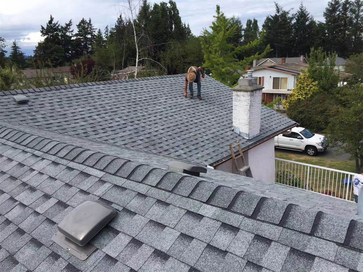 This image features the completed result of a residential roof replacement project in Toronto, showcasing newly installed asphalt shingles with a clean and uniform finish. The upgraded roofing system includes proper ventilation components and carefully aligned shingle placement to ensure long-term durability and protection against Toronto’s changing weather conditions. The project focuses on improving structural reliability, waterproof performance, and overall exterior appearance. Installed by a professional Toronto roofing and renovation team, the new roof enhances curb appeal while providing dependable, energy-efficient protection for the home throughout all seasons.