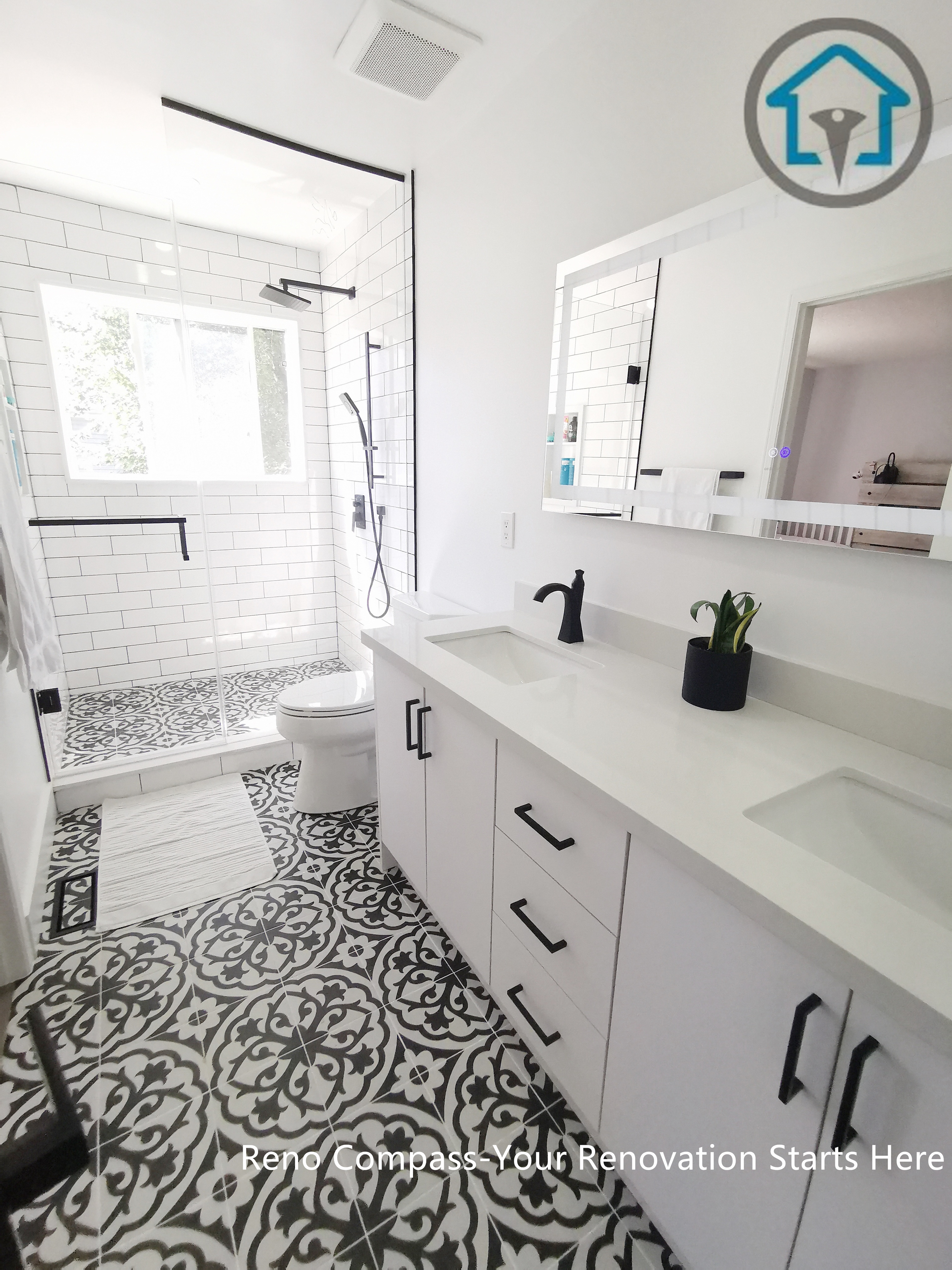 This Ajax bathroom renovation showcases a bright, modern layout featuring a white vanity, matte black hardware, and a frameless glass shower. The bold patterned floor tiles add visual depth while maintaining a clean, cohesive look, creating a bathroom that balances style, comfort, and everyday functionality.