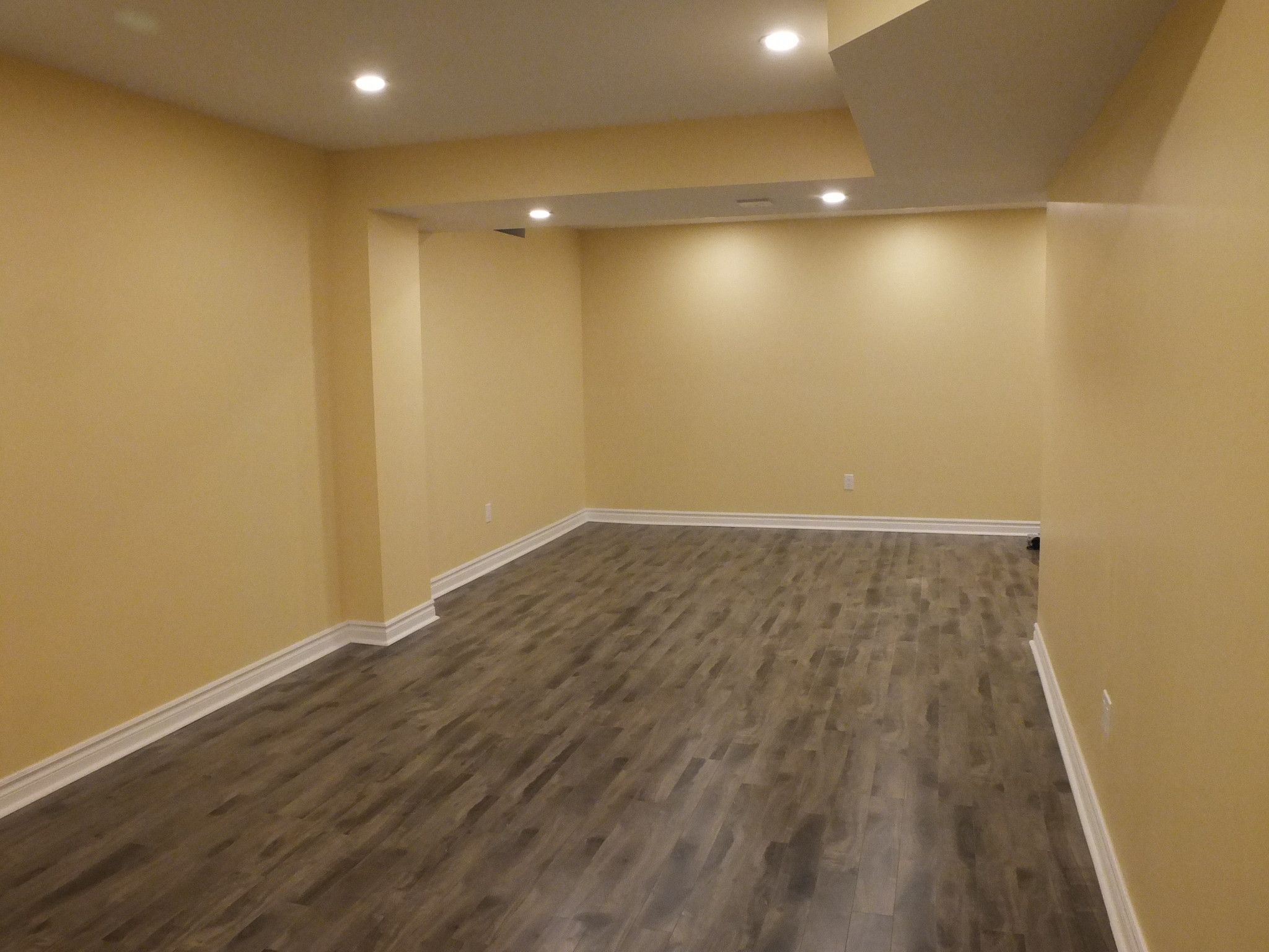 This Vaughan basement renovation project was completed by a professional Toronto Renovation Company, transforming the lower level into a warm and functional living space. Featuring durable wood-look flooring, clean wall finishes, and well-planned recessed lighting, the basement now offers a versatile area suitable for a family lounge, entertainment zone, or home gym. The design focuses on comfort, practicality, and long-term property value, making it an ideal reference for homeowners in the GTA considering a basement renovation or finishing project.