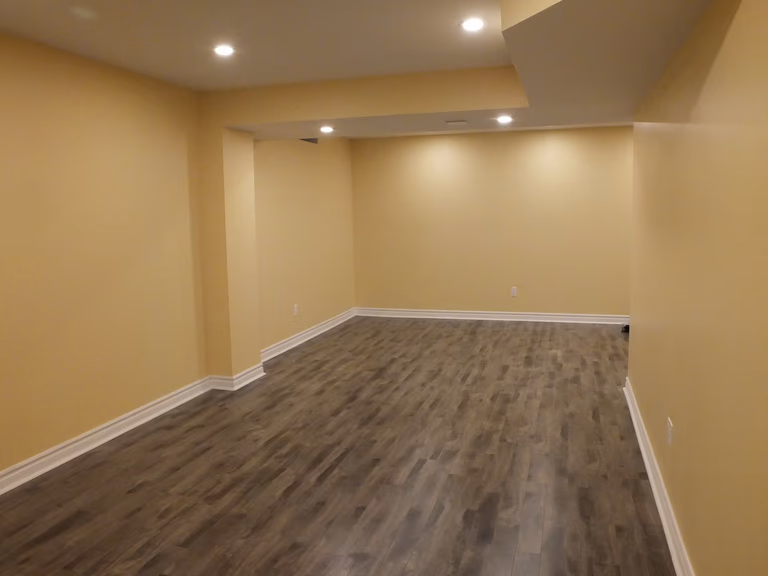 This Vaughan basement renovation project was completed by a professional Toronto Renovation Company, transforming the lower level into a warm and functional living space. Featuring durable wood-look flooring, clean wall finishes, and well-planned recessed lighting, the basement now offers a versatile area suitable for a family lounge, entertainment zone, or home gym. The design focuses on comfort, practicality, and long-term property value, making it an ideal reference for homeowners in the GTA considering a basement renovation or finishing project.