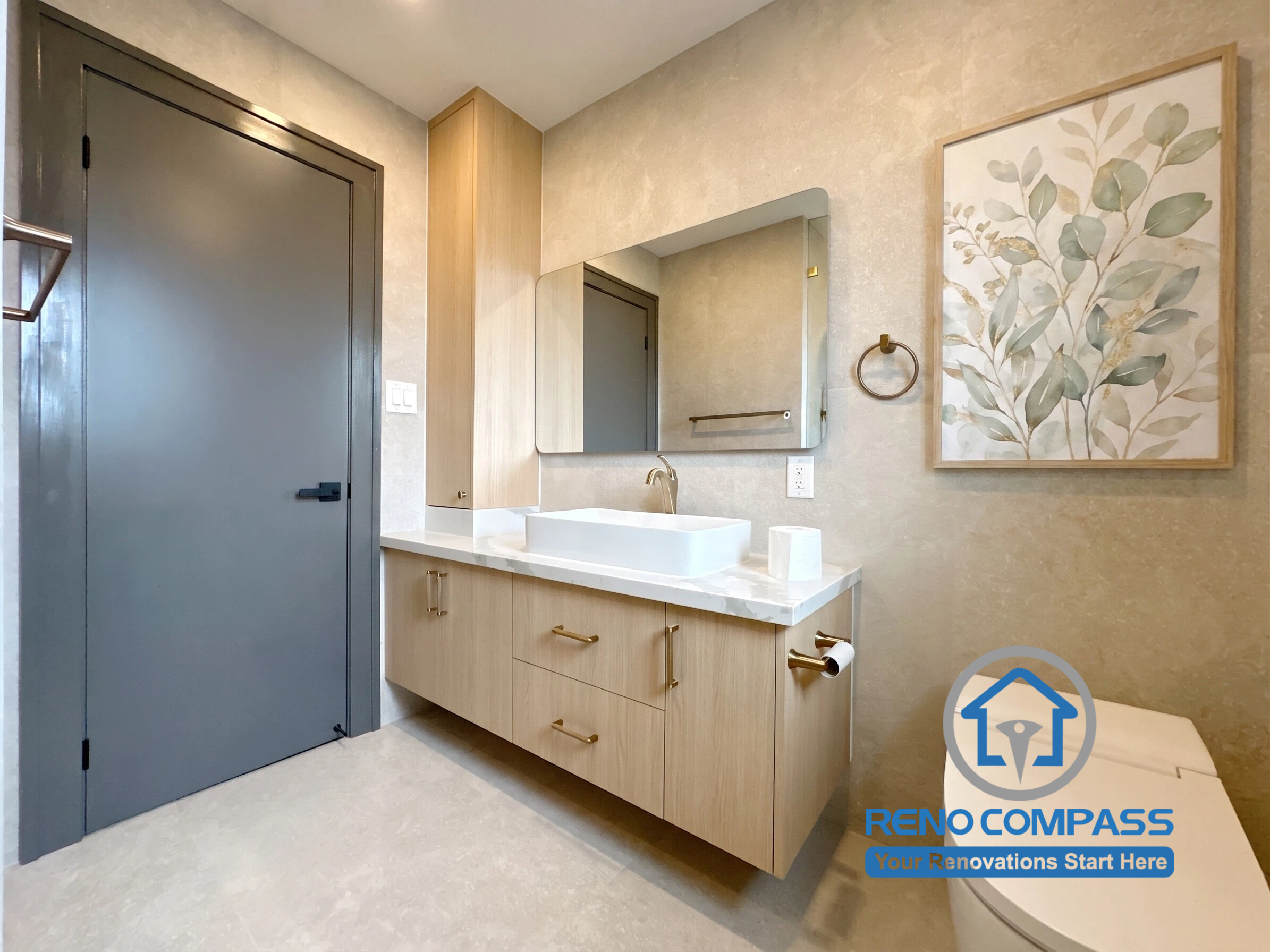 This contemporary powder room renovation features a floating vanity, warm wood cabinetry, premium brass fixtures, and a minimalist design aesthetic. The combination of soft textures, modern finishes, and smart storage solutions creates an elegant and functional space for everyday use. Project completed by Reno Compass, serving Markham, Toronto, Richmond Hill, Vaughan, and the Greater Toronto Area.