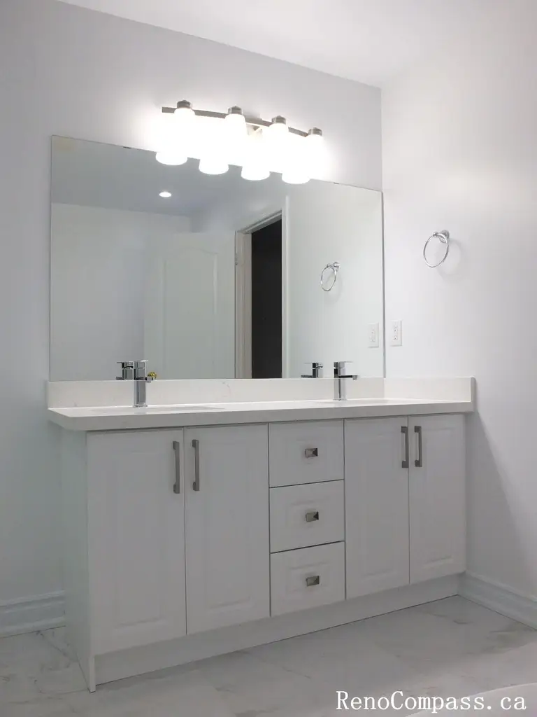 This Richmond Hill bathroom renovation showcases a contemporary double-sink vanity, frameless glass shower, and marble-look tile finishes. Completed by an experienced Toronto renovation company, the design focuses on clean lines, practical storage, and a bright, spacious layout. The combination of modern fixtures, neutral tones, and elegant materials creates a refined and functional bathroom ideal for everyday comfort and long-term durability.